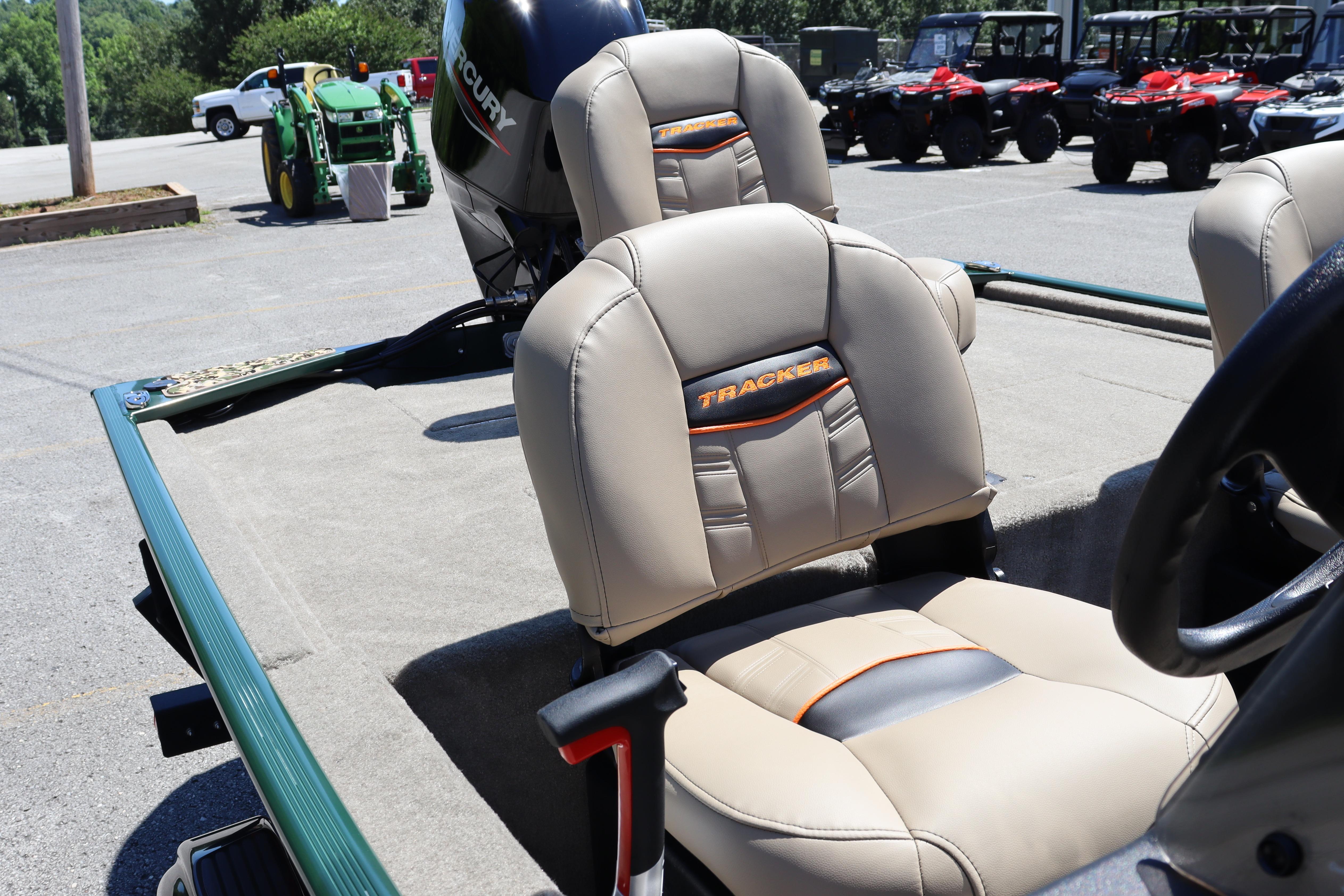 2026 Tracker Bass Tracker Classic Limited boat seats with Mercury engine in outdoor setting.