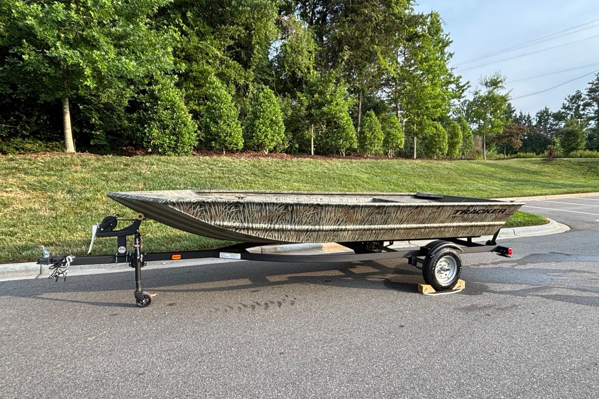 2026 Tracker Grizzly 1648 Utility boat on trailer, parked outdoors.