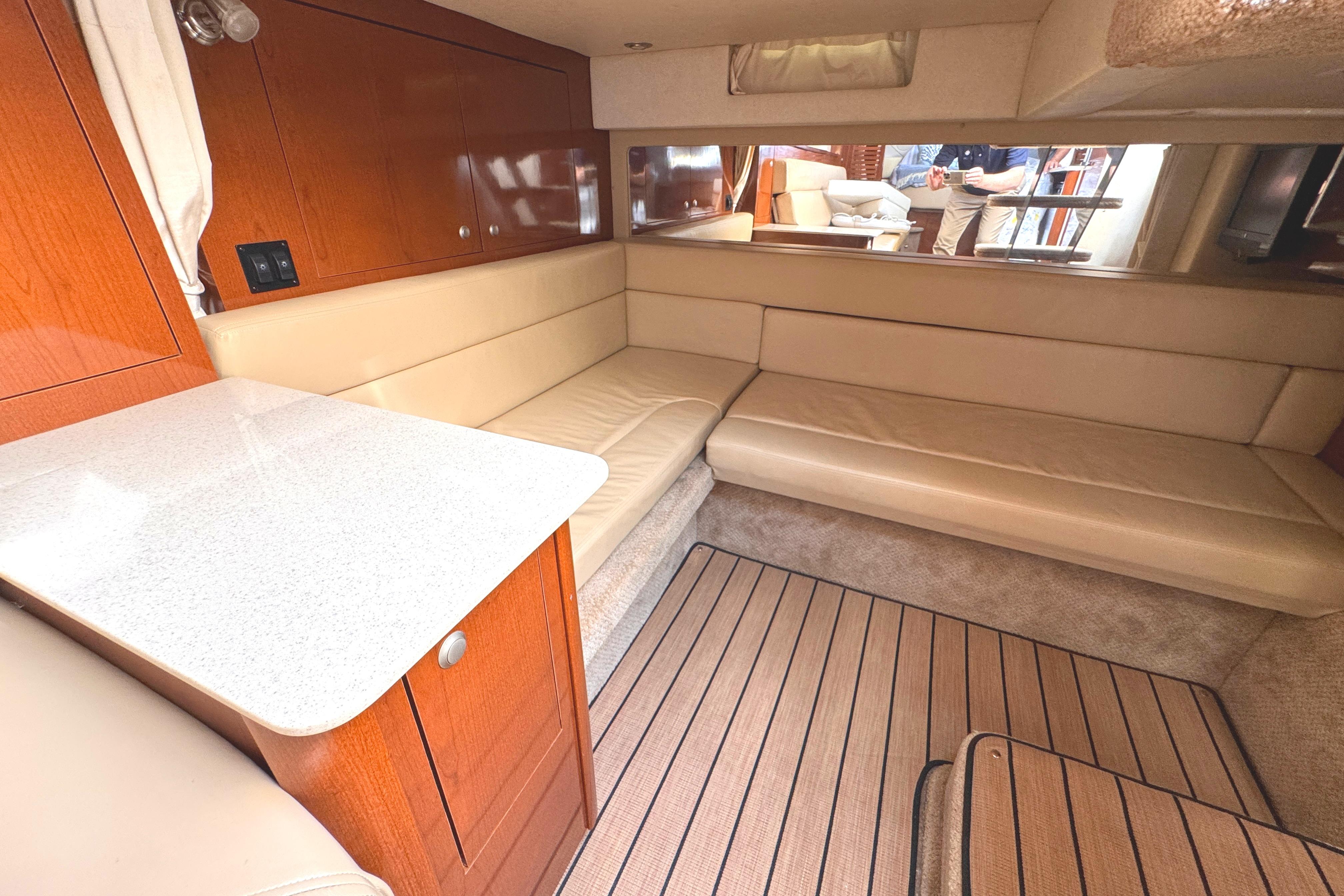 Interior of 2008 Sea Ray Sundancer 350 yacht with beige seating and wooden cabinetry.