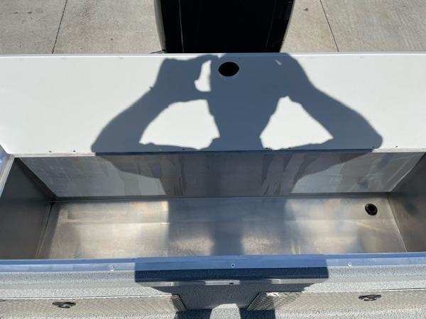 2025 Spartan 185 Astoria boat interior with shadow on metal surface.
