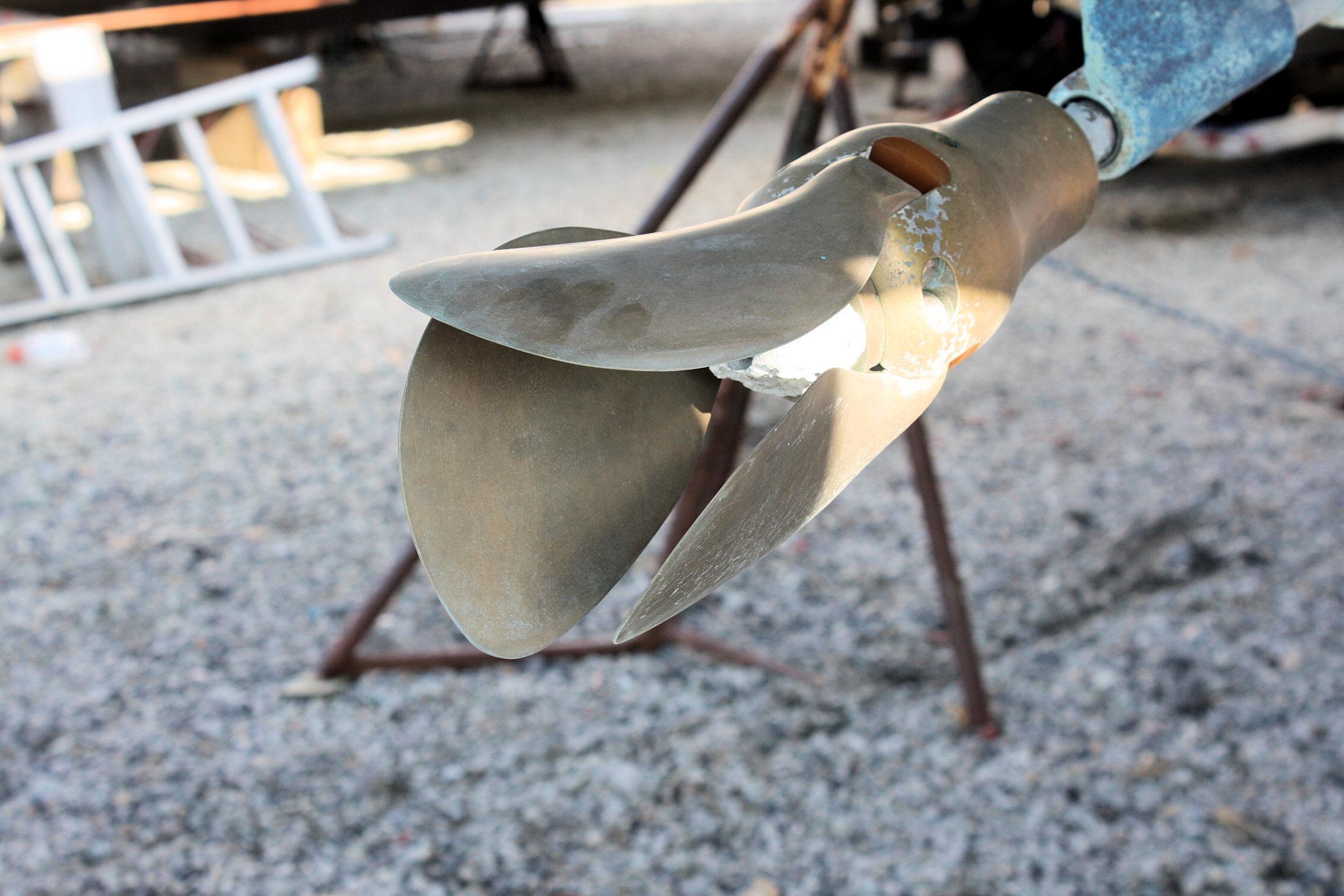 Propeller of 1987 Ericson 38-200 sailboat on gravel surface.