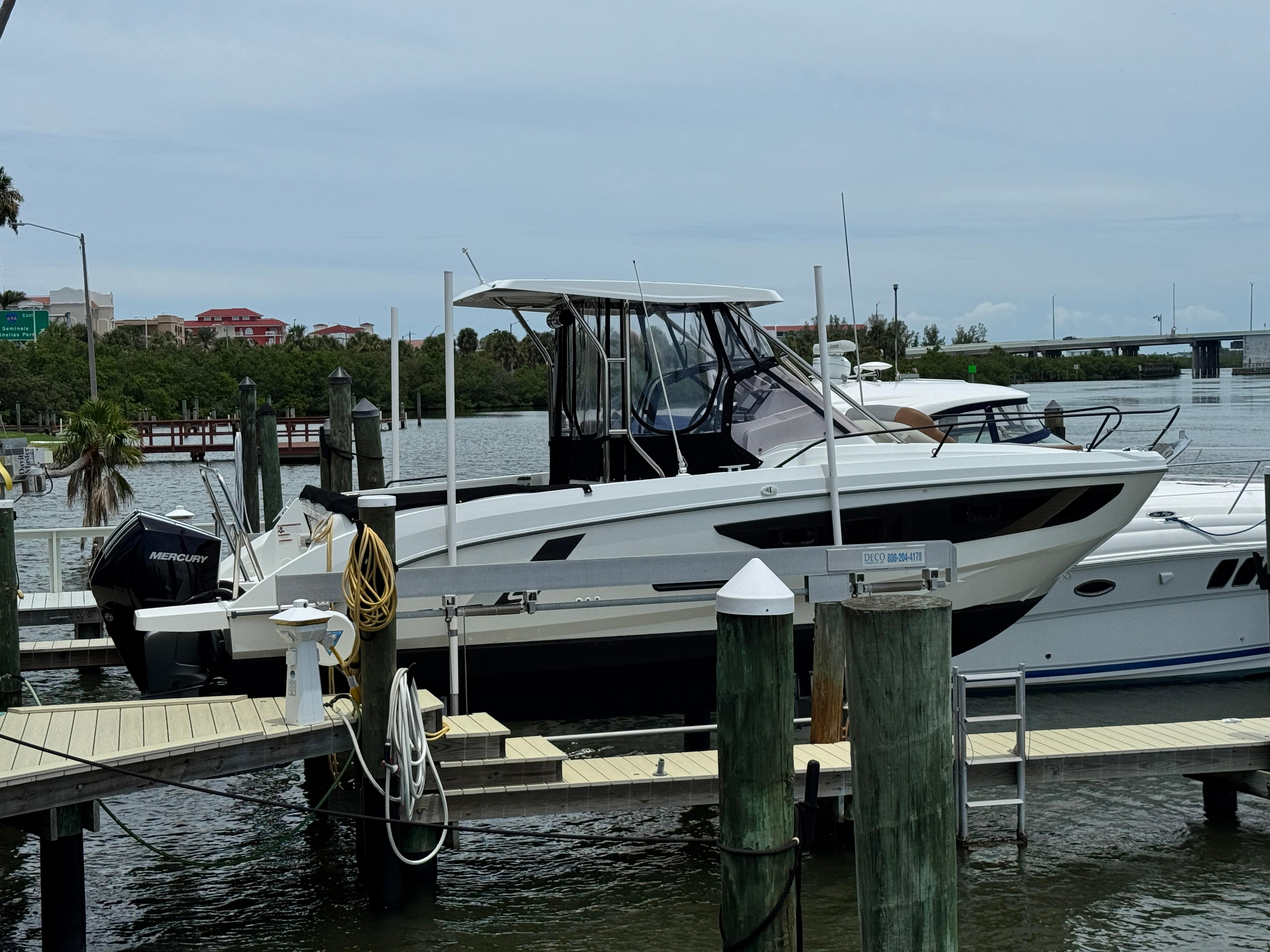2022 Beneteau Flyer 9 SUNdeck docked at marina with Mercury outboard engine.