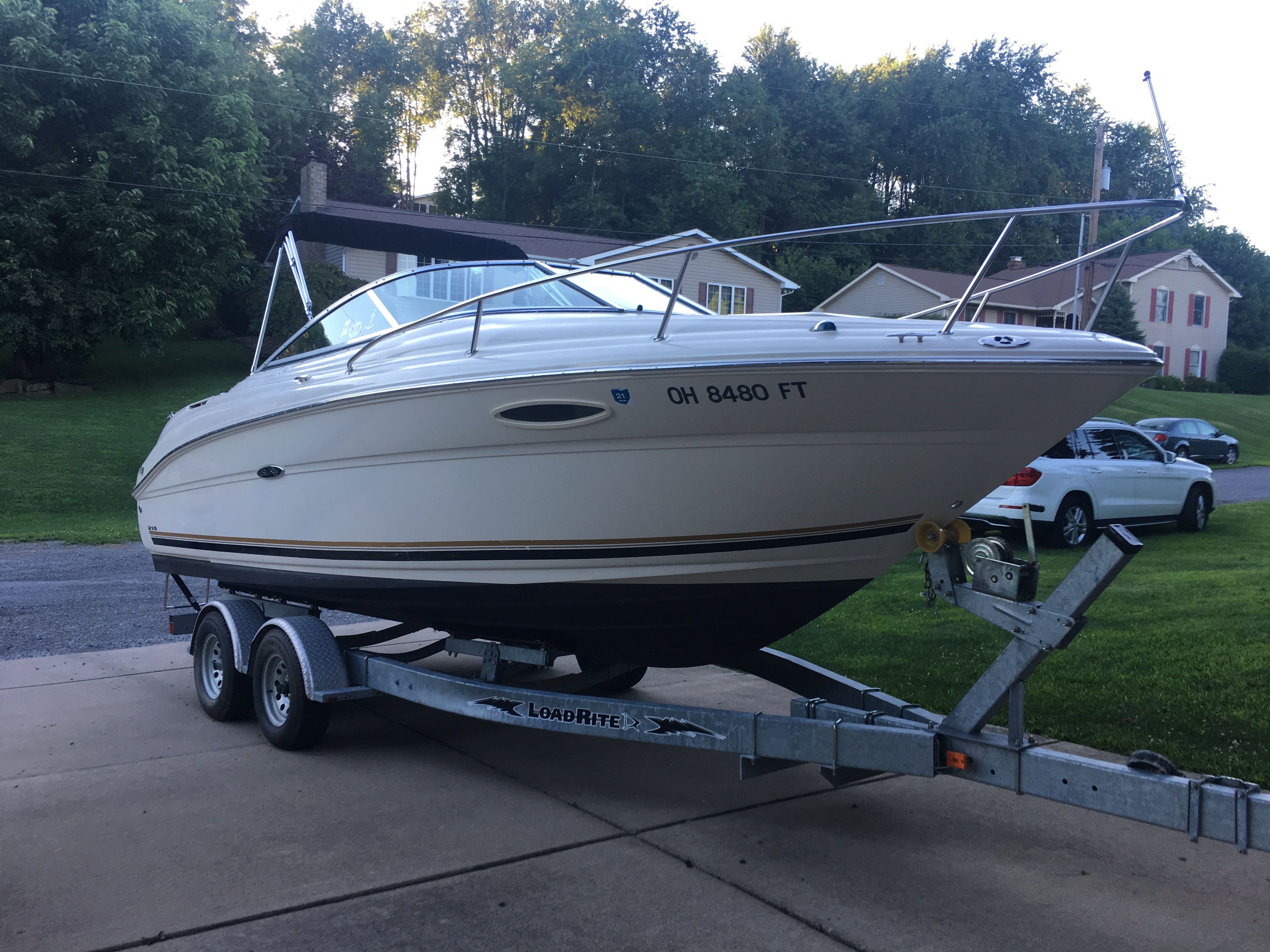 2006 Sea Ray 215 Weekender on trailer in driveway.