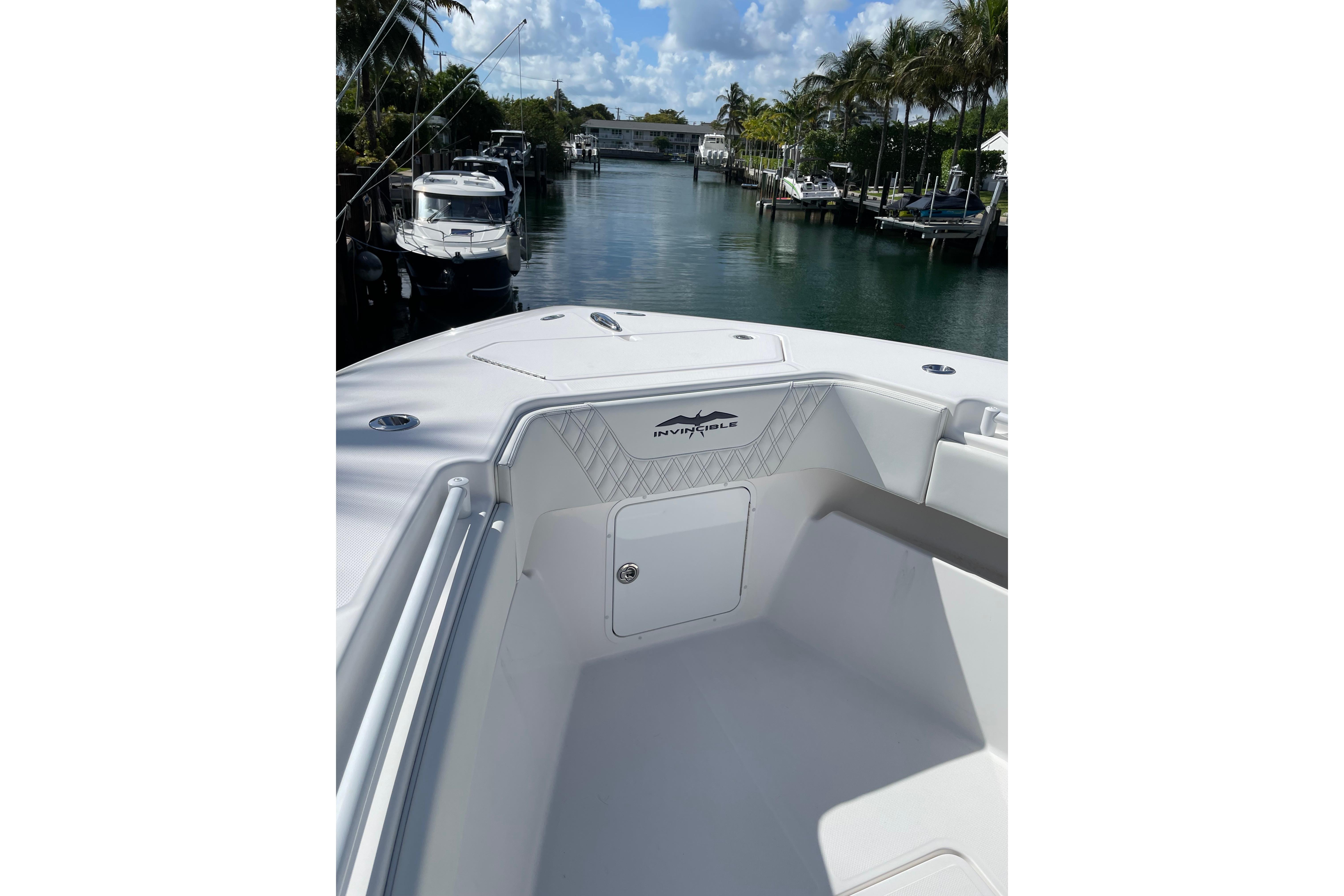 2024 Invincible 36 Open Fisherman boat docked in a scenic marina.
