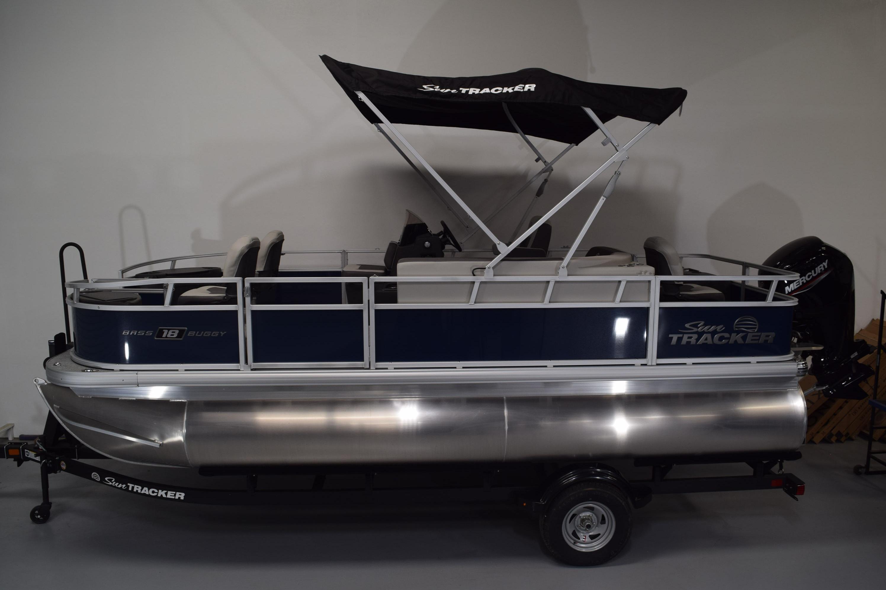 2026 Sun Tracker Bass Buggy 18 DLX pontoon boat with canopy and trailer.