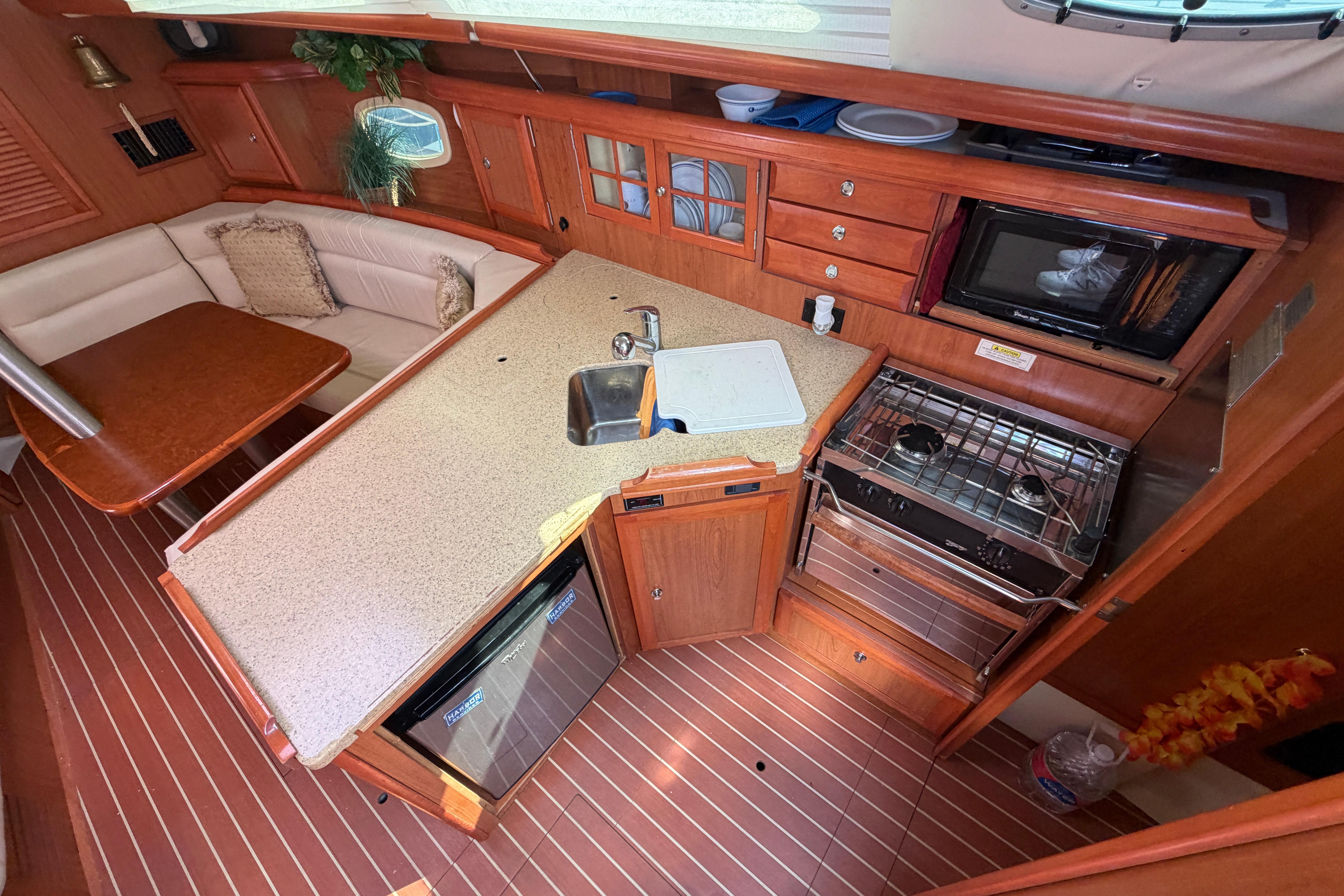 Luxurious 2008 Hunter 36 yacht interior with modern kitchen and cozy seating area.