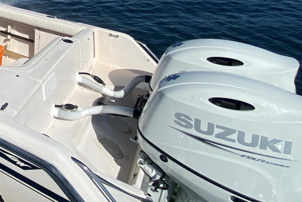 1996 Grady-White Chase 263 boat with dual Suzuki outboard motors on the water.