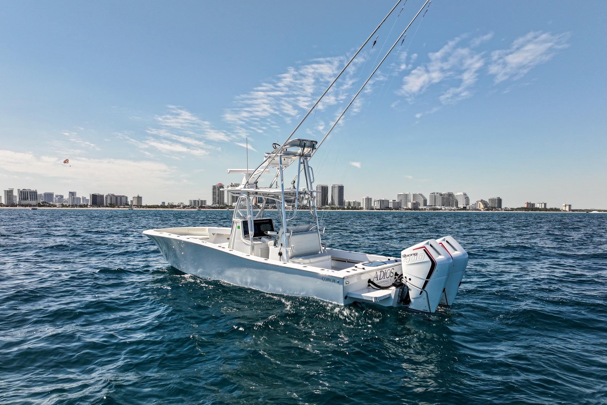2026 Conch 33 boat on ocean with city skyline in background.