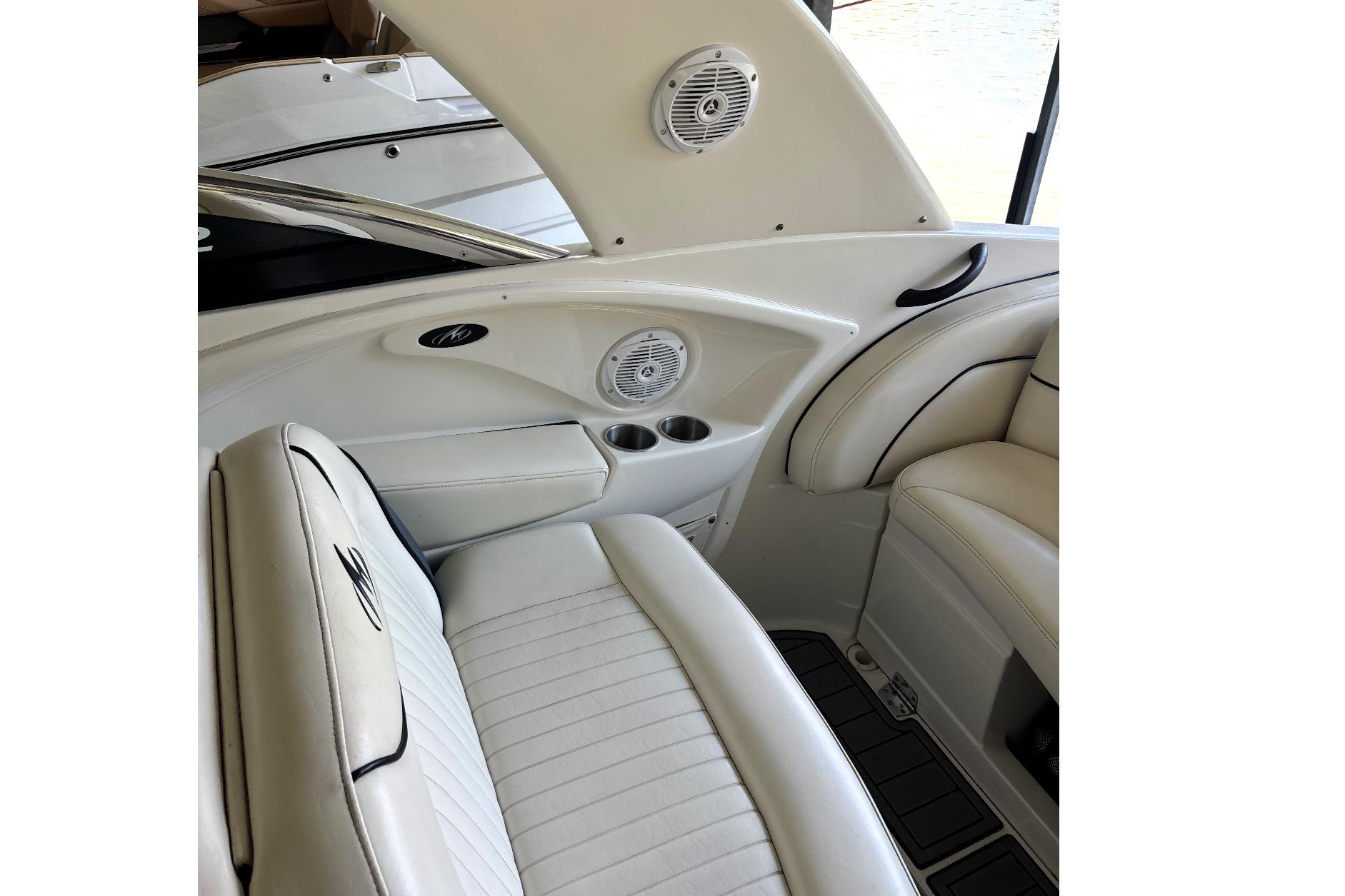 Interior of 2007 Monterey 298SSX Super Sport boat with white seating and built-in speakers.