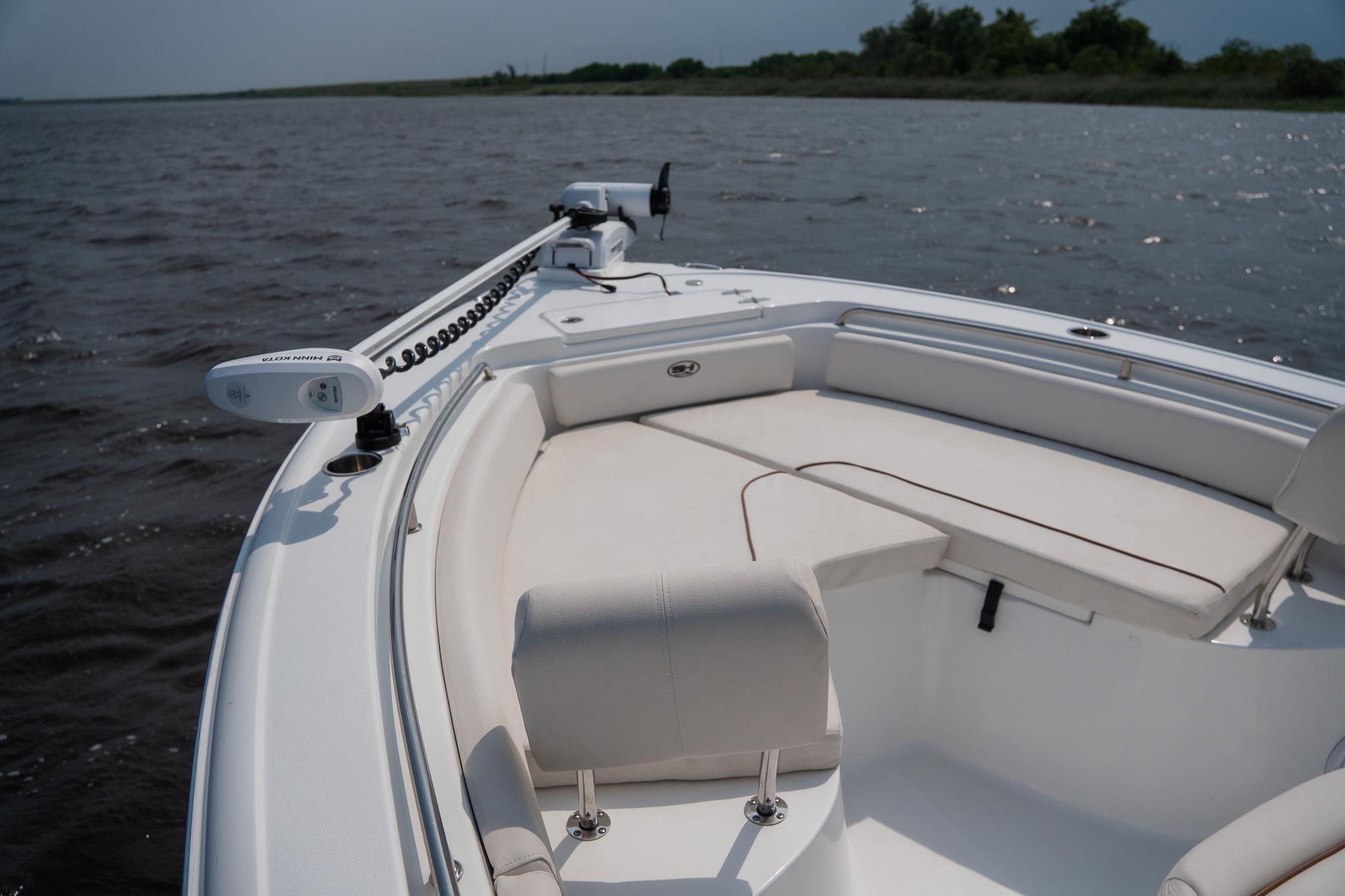 2022 Sea Hunt Ultra 229 boat with spacious seating on calm waters.
