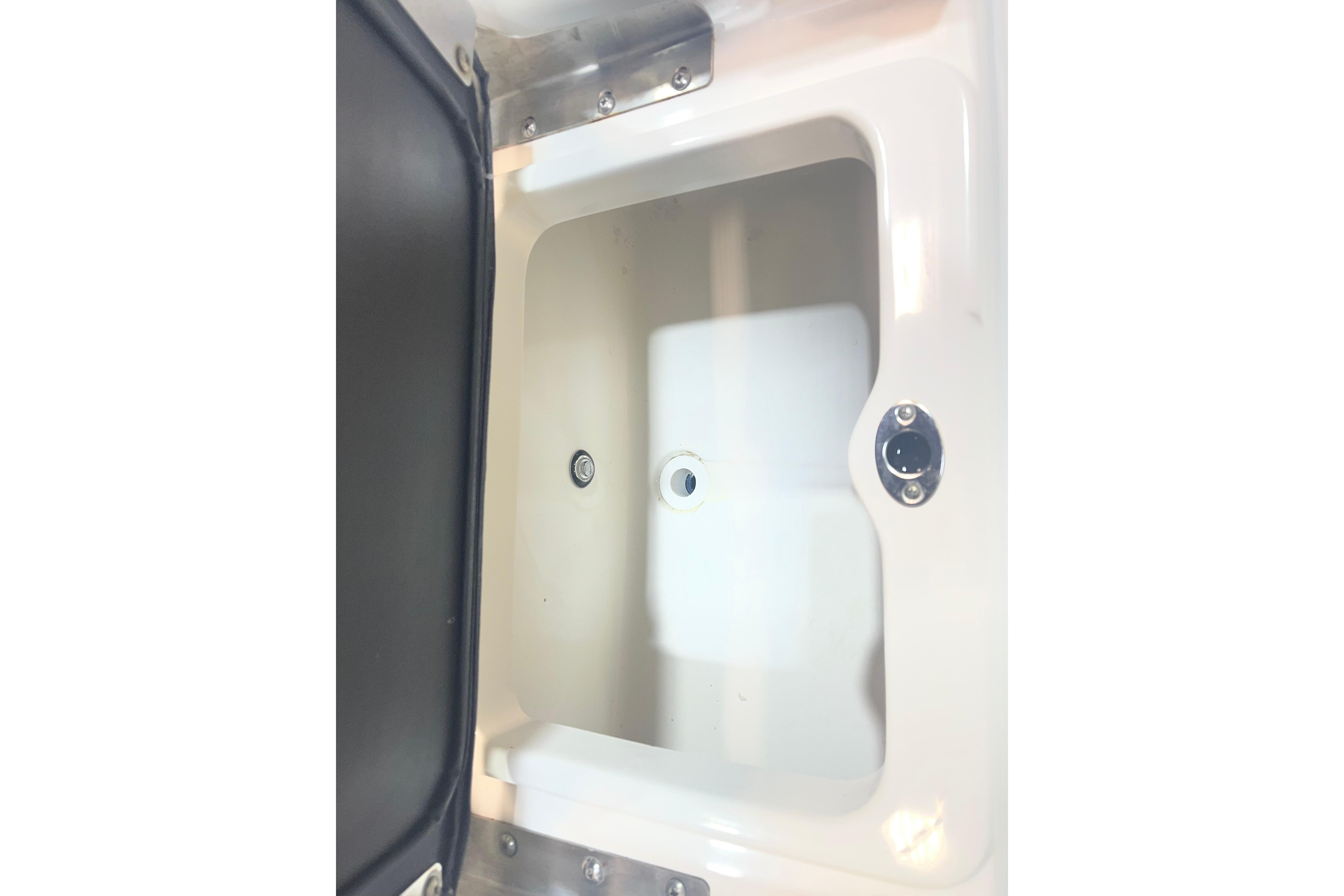 2023 NauticStar 227 XTS boat storage compartment, open and empty.