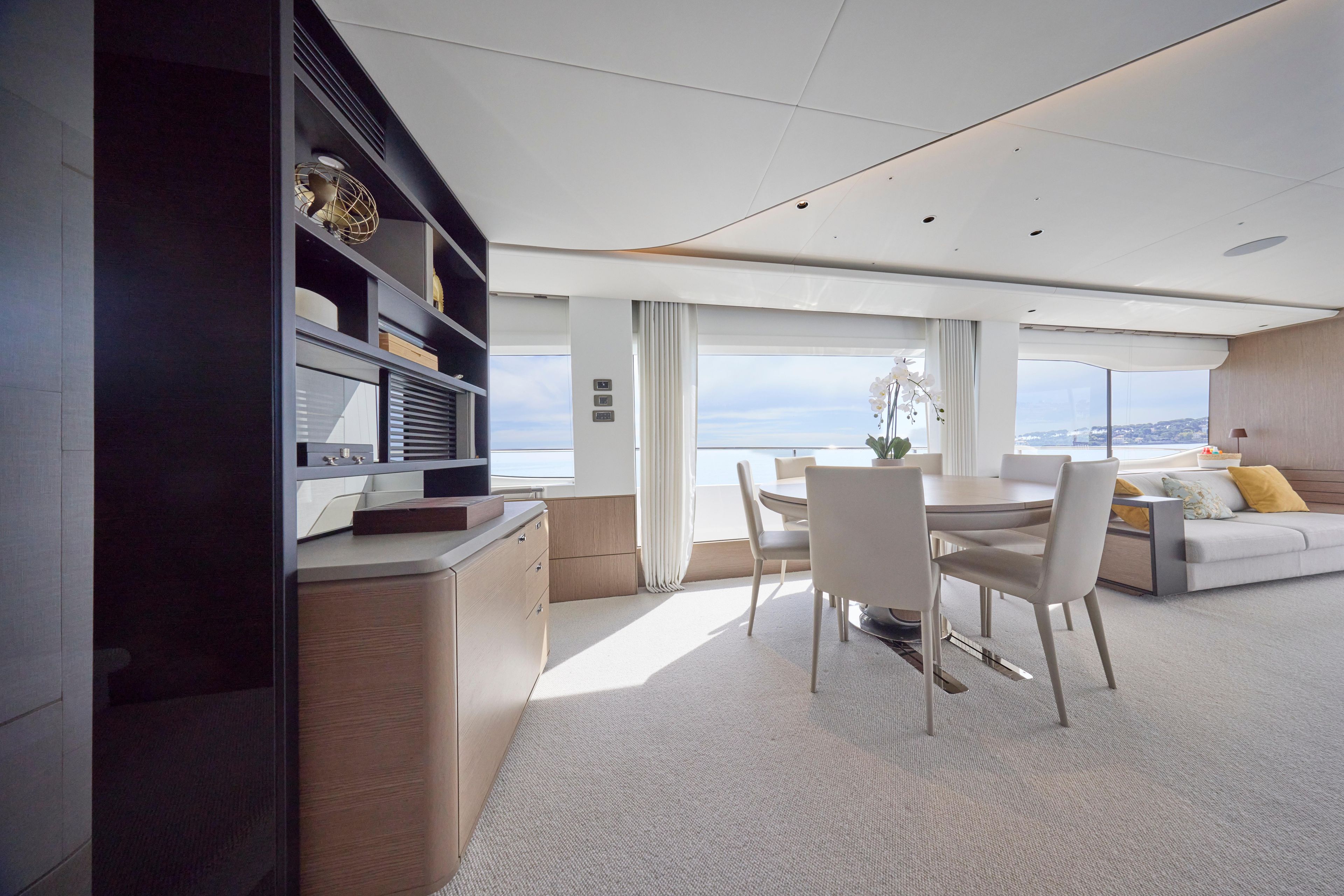 Luxurious interior of 2024 Princess Y85 yacht with dining area and ocean view.