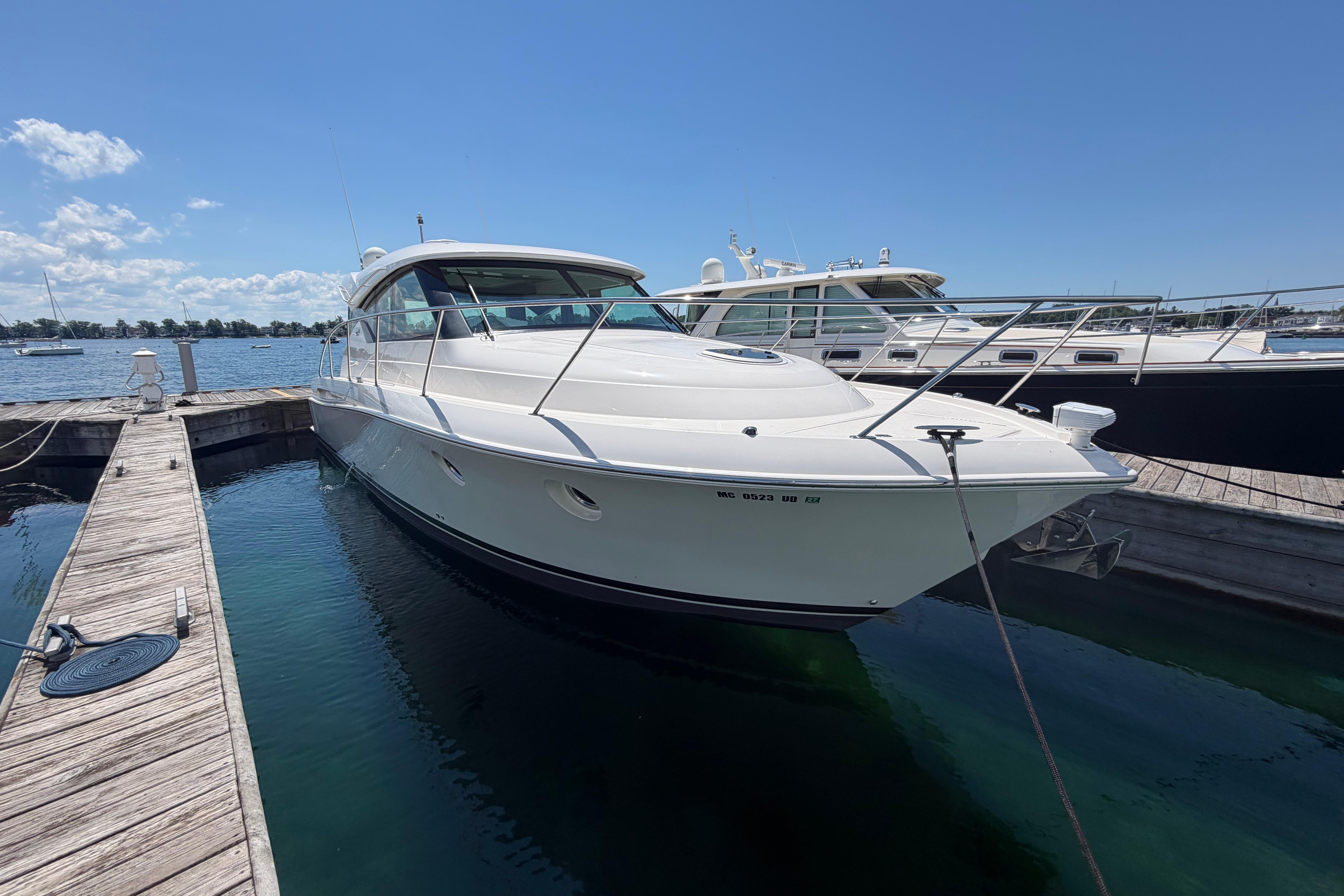 2016 Tiara Yachts C39 Coupe docked at marina under clear blue sky.