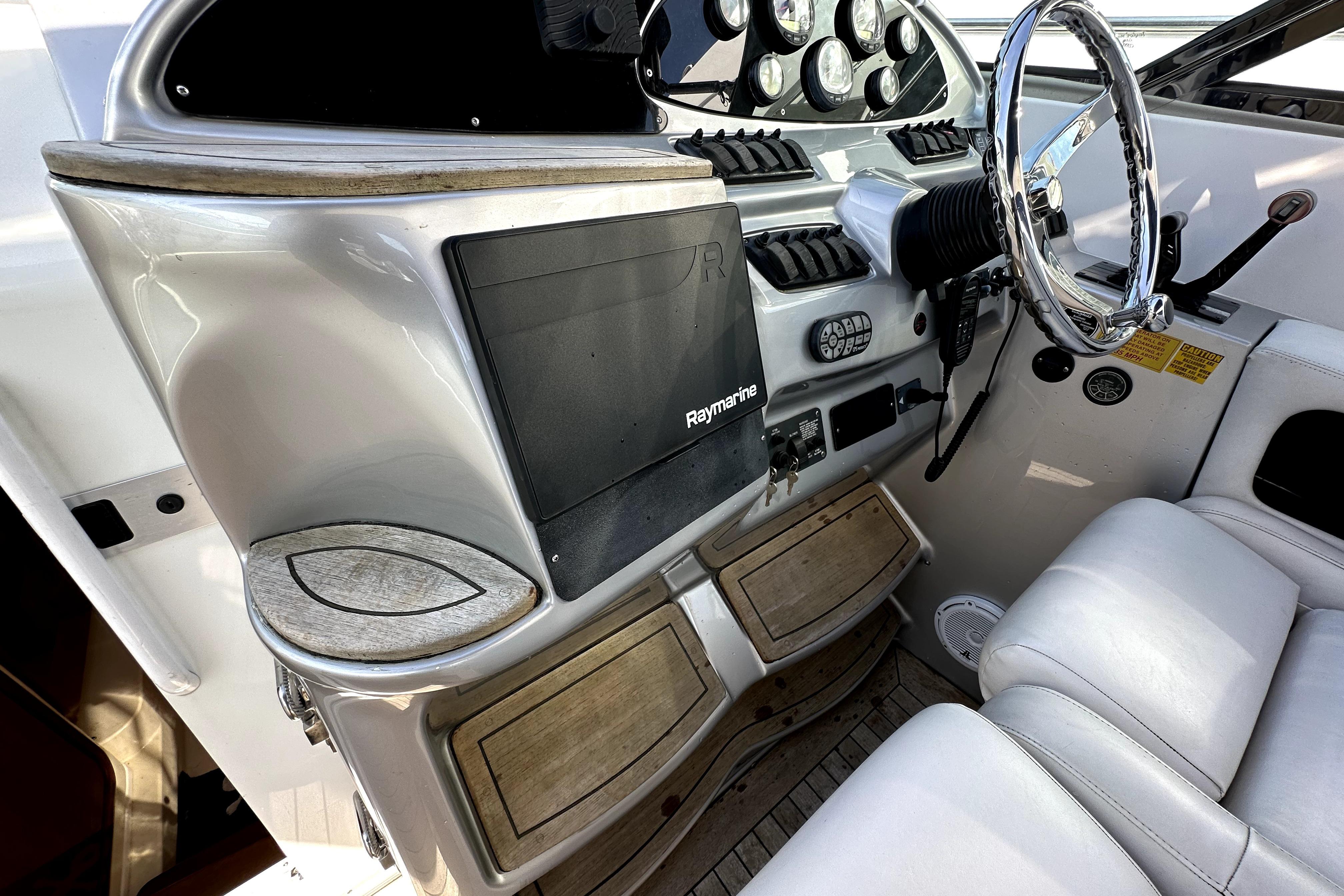 2003 Donzi 39 ZSC boat cockpit with steering wheel and navigation system.