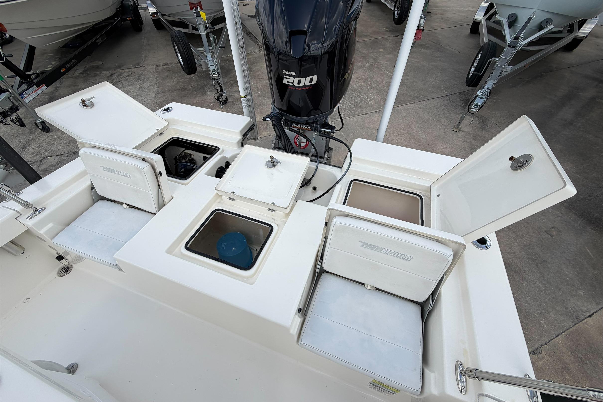 2017 Pathfinder 2200 TRS boat with open storage compartments and Yamaha 200 engine.
