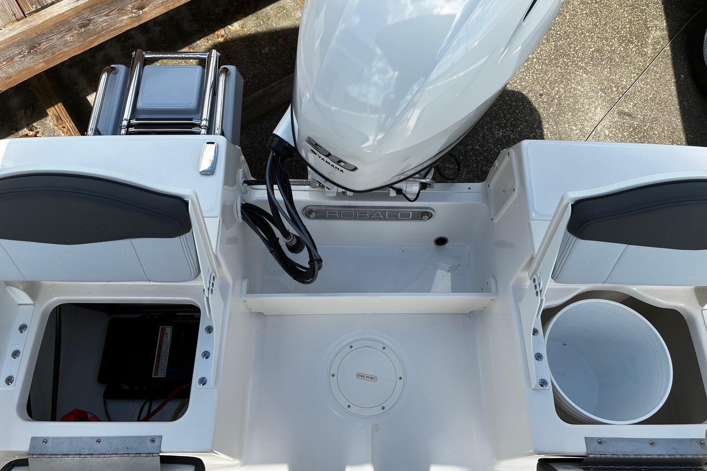 2026 Robalo R160 Center Console boat interior with storage compartments and engine view.