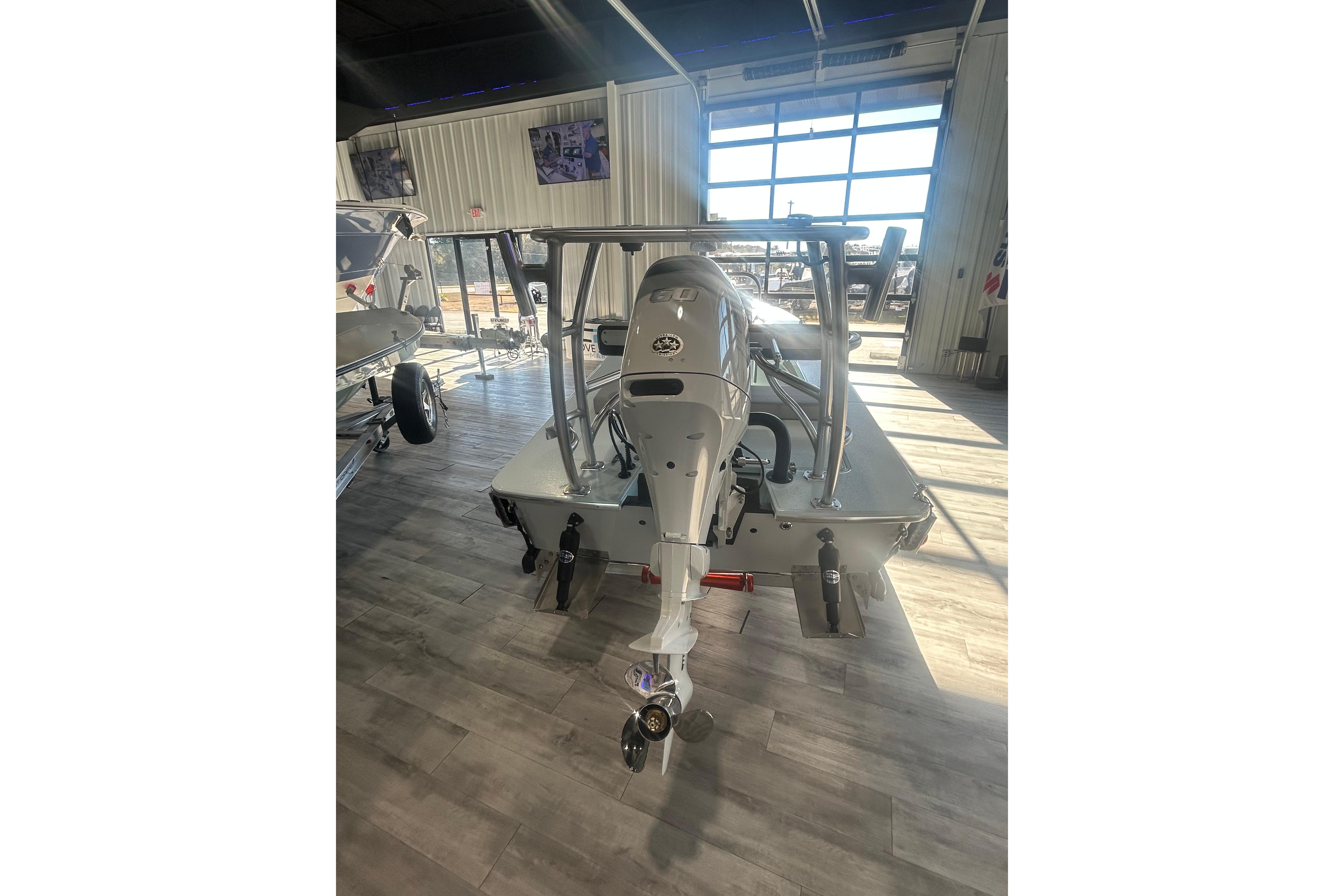 2026 East Cape Evo 17X boat with outboard motor in showroom.