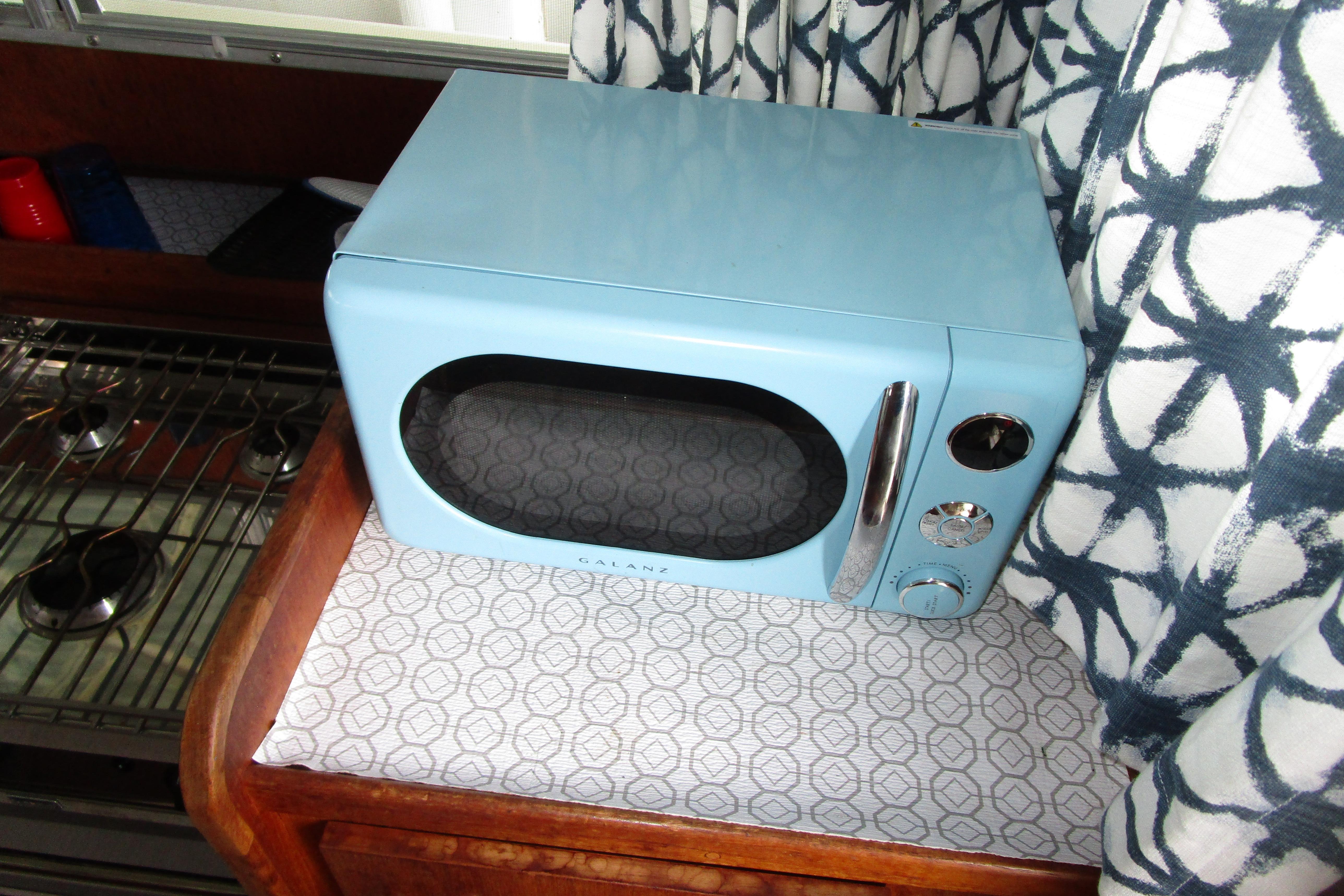 Retro blue microwave in 1984 Tollycraft 26 Sedan boat interior.