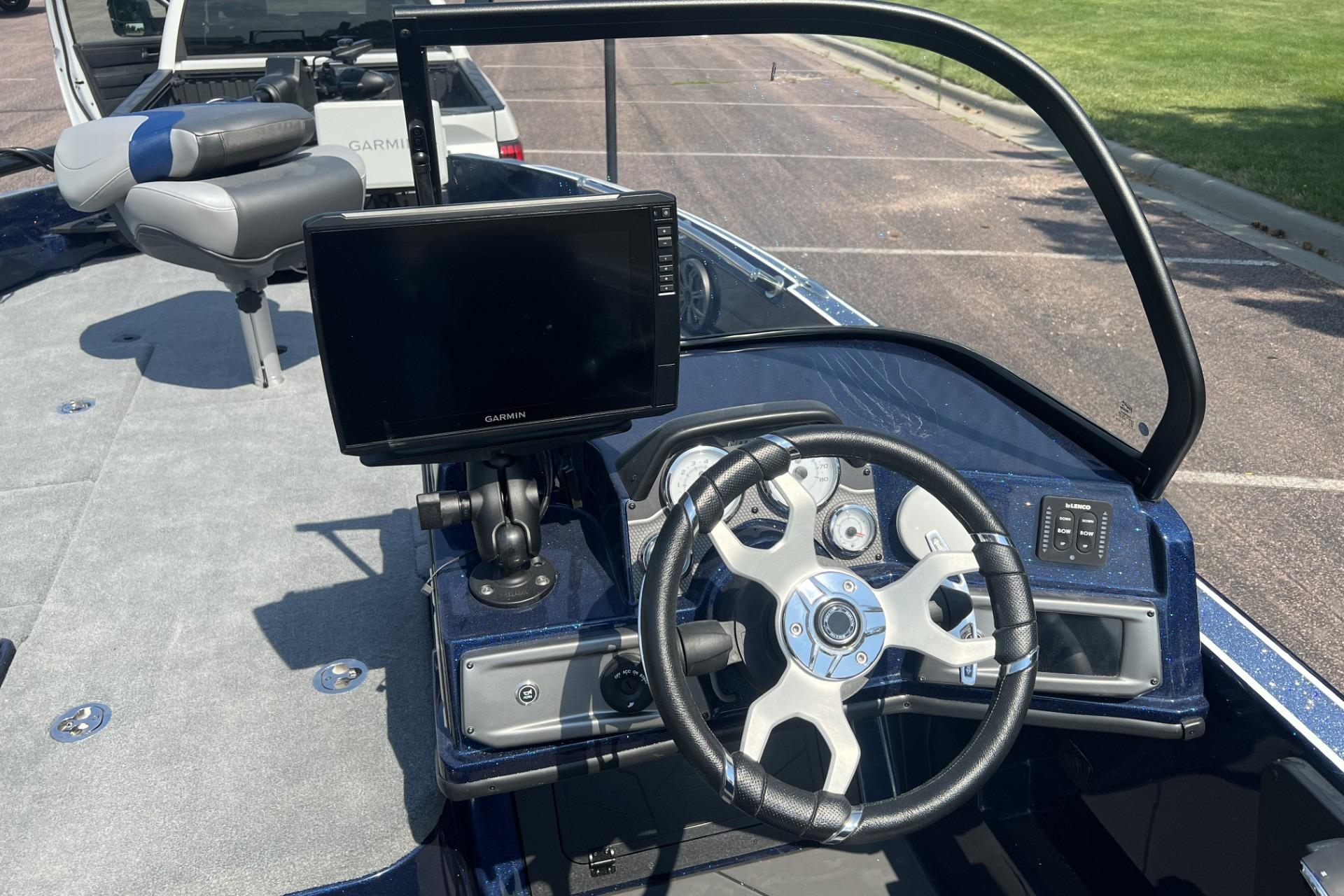 Interior of a 2026 Nitro ZV21 Pro boat with steering wheel and Garmin display.