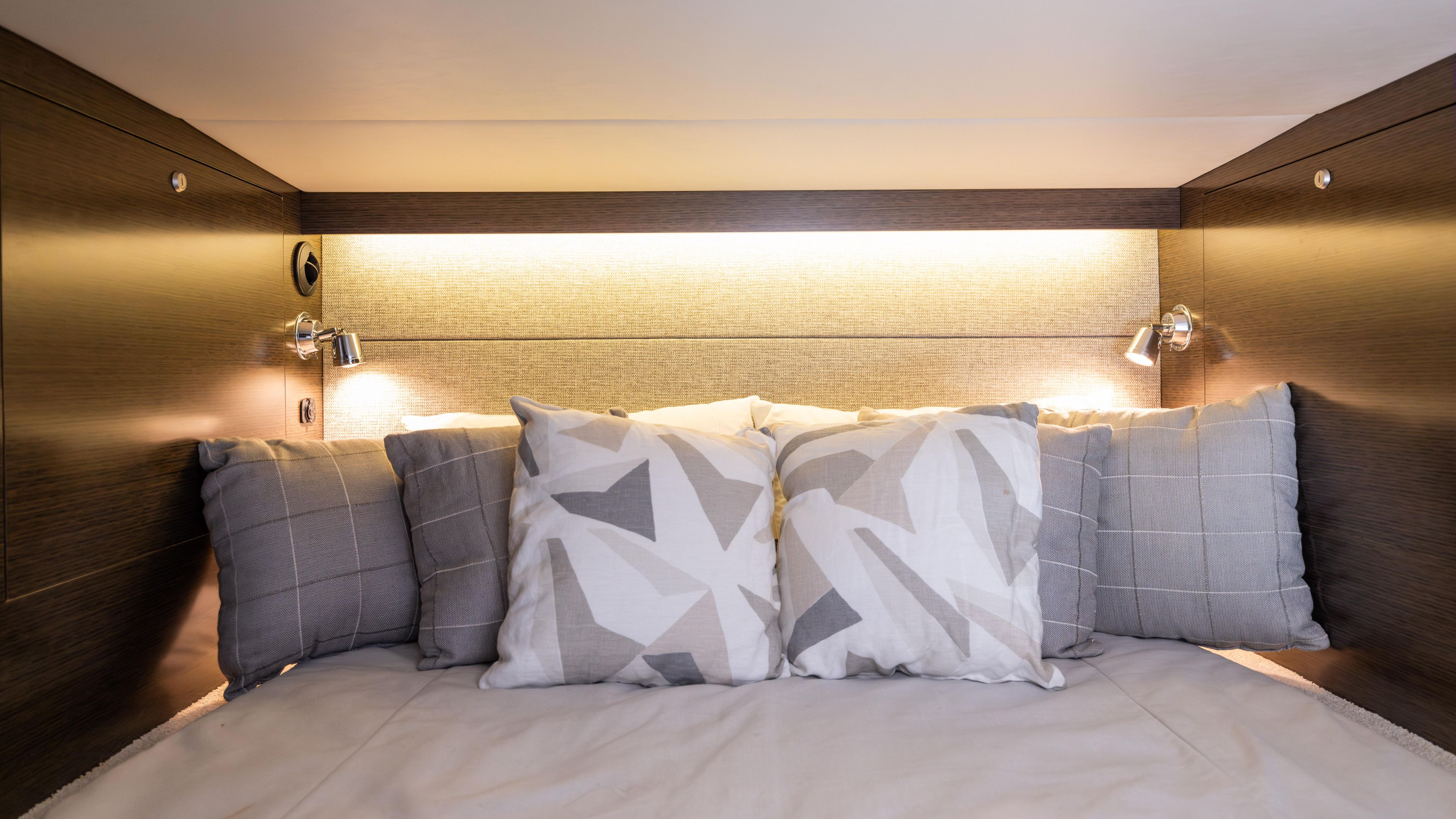 Cozy cabin bed with decorative pillows in 2020 Cruisers Yachts 38 GLS OB.
