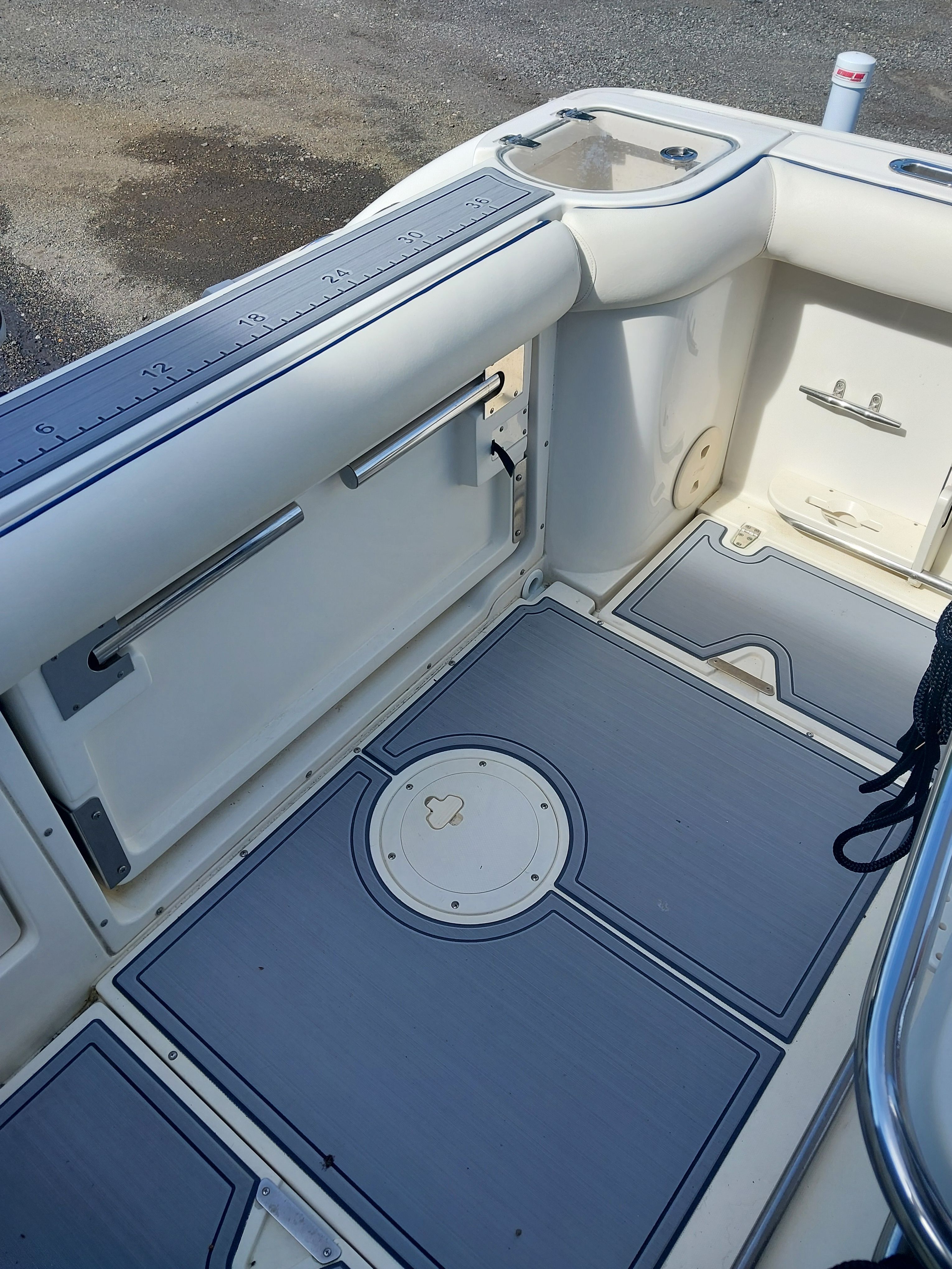 The image shows the cockpit of a 2005 Boston Whaler 240 Outrage with durable flooring.