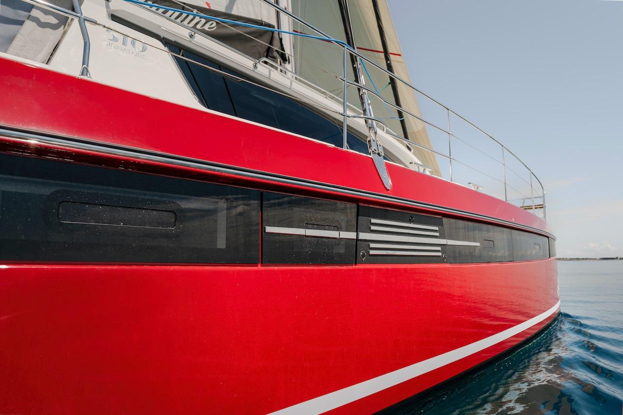 Red Privilege Signature 510 yacht from 2025 on calm water.