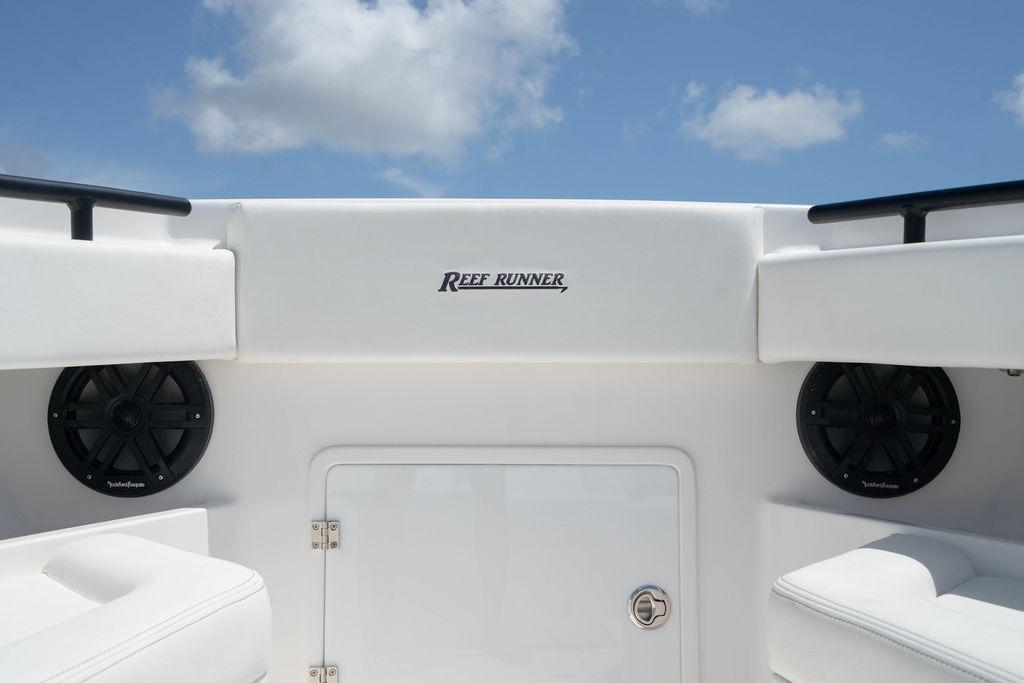 2027 Reef Runner 340 boat interior with speakers and clear sky background.