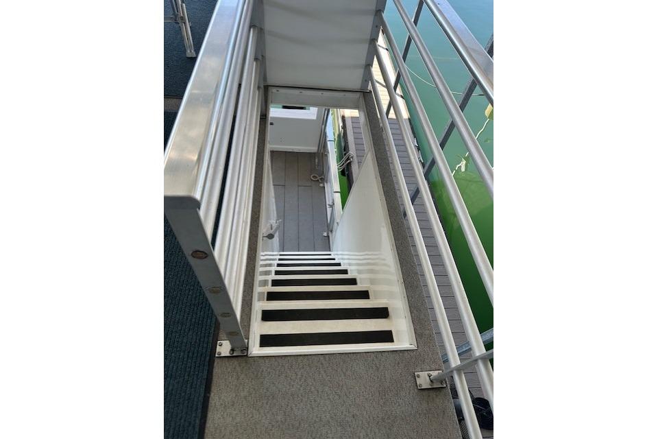 Staircase on 2008 Destination Yachts 45X14, leading to lower deck with railing.