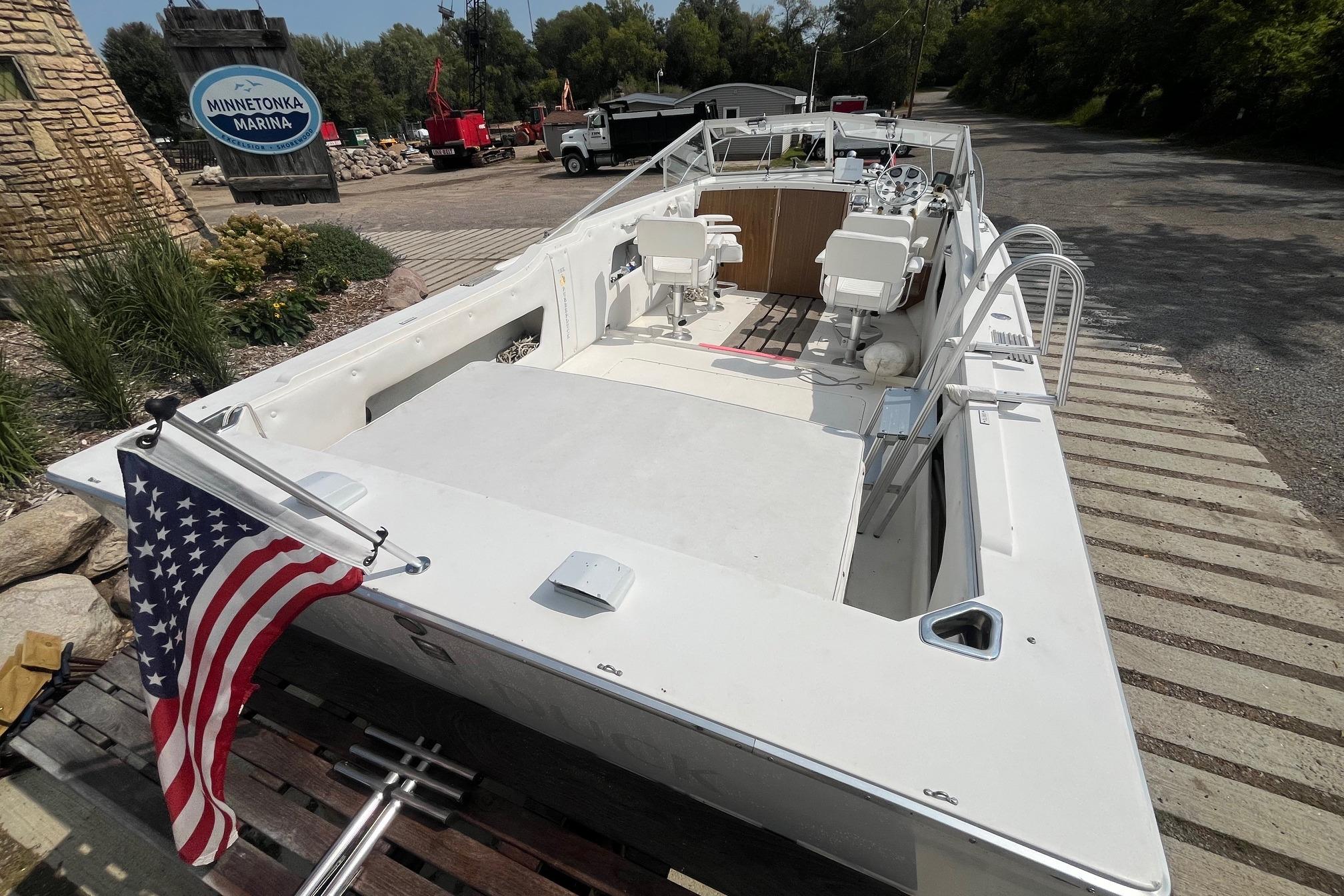 1975 Bertram 26 Moppie boat at Minnetonka Marina with American flag.