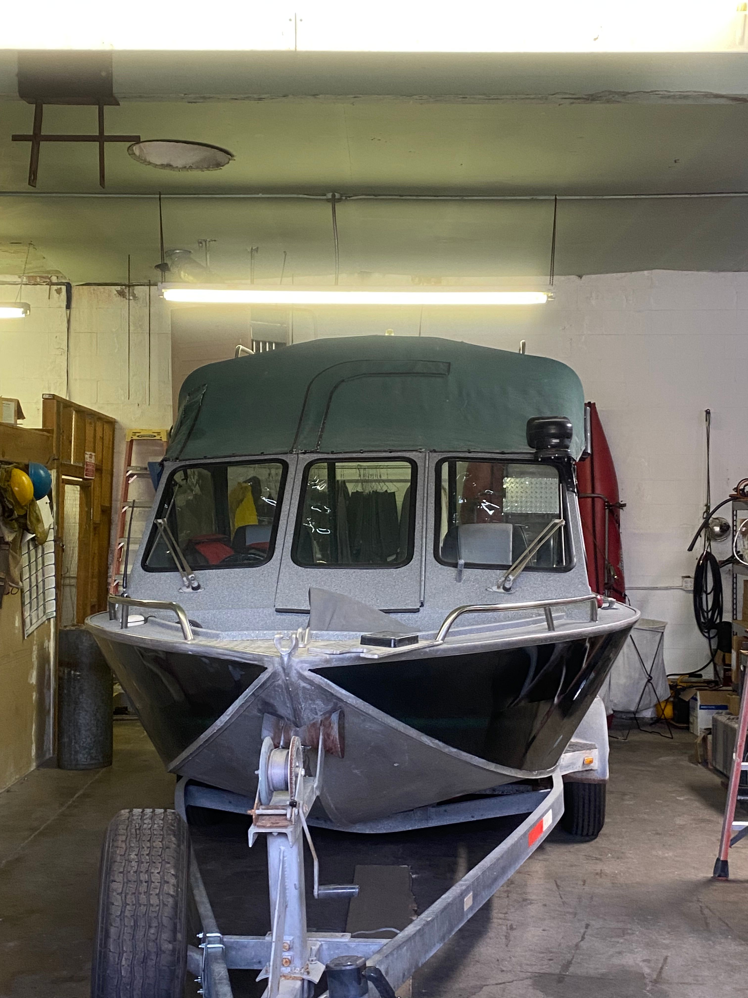 1993 Jetcraft Fastwater boat in a workshop on a trailer.