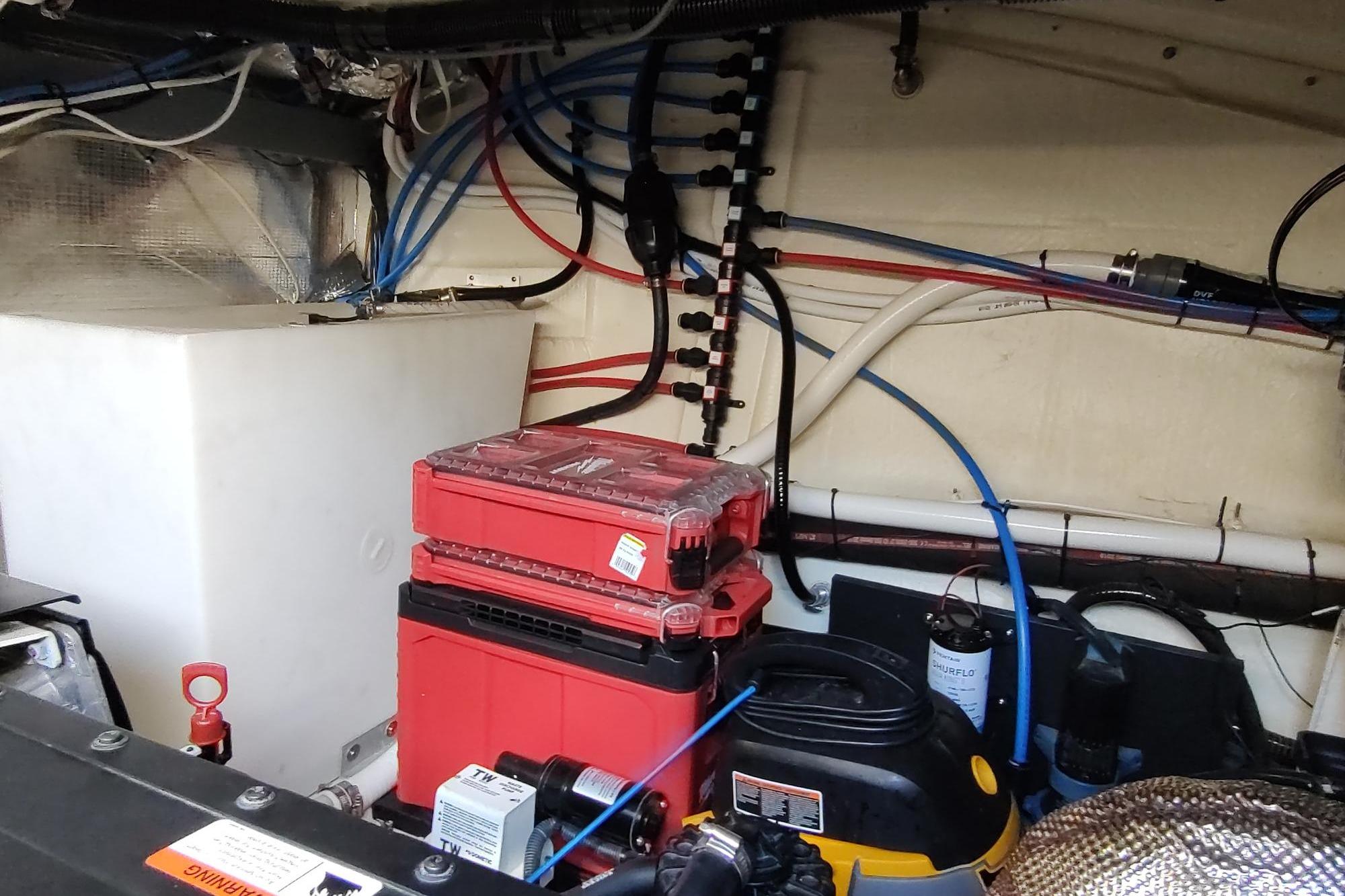 Engine room of 2021 Regal 42 Fly yacht with wiring and equipment.