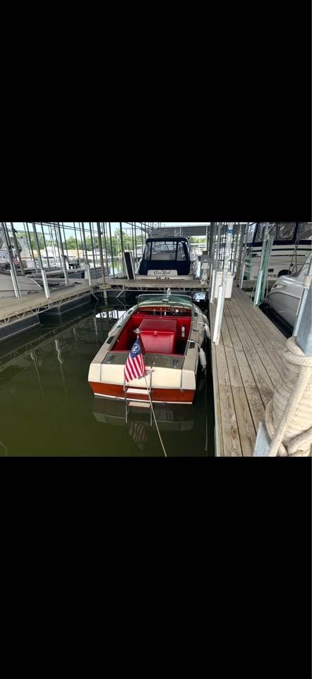 1965 Century Sabre boat docked with American flag.