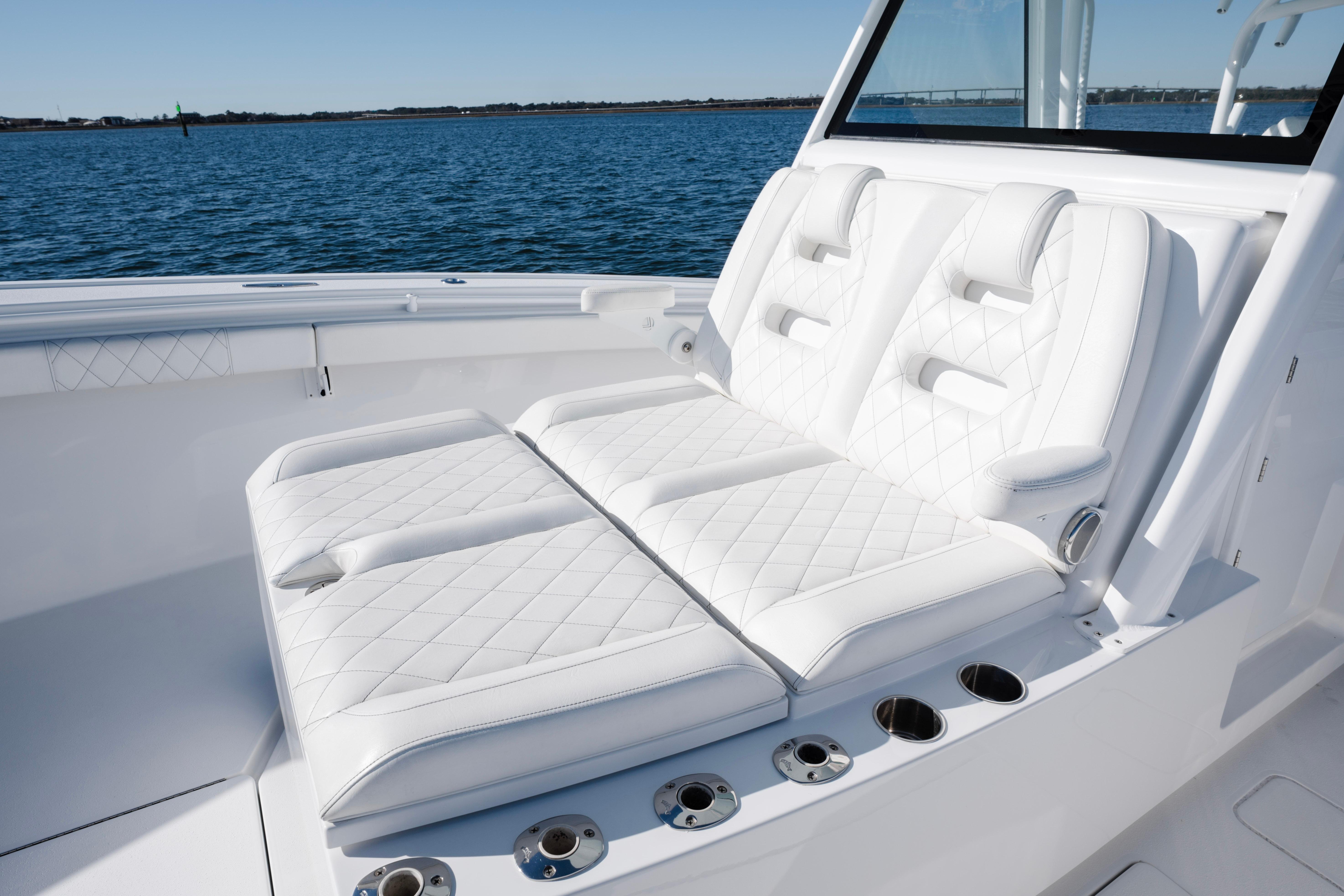 Luxurious seating on 2021 Onslow Bay 41 Tournament Edition boat, with ocean backdrop.