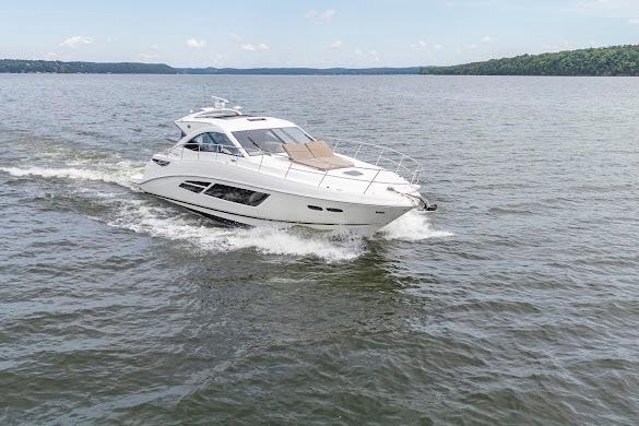 2016 Sea Ray Sundancer 510 cruising on a calm lake under a clear sky.