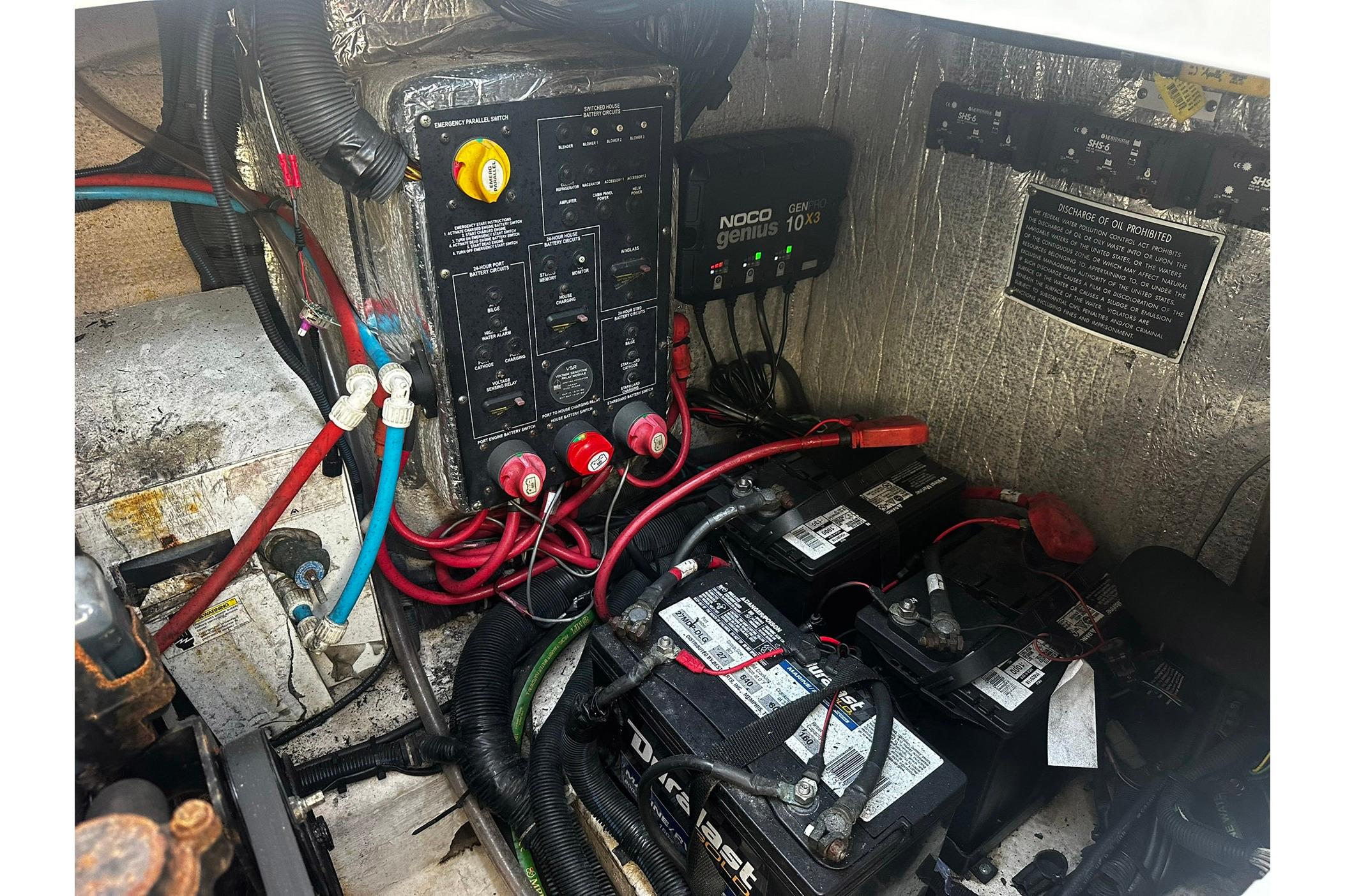 Electrical system of a 2012 Rinker 310 Express Cruiser LE with batteries and wiring.
