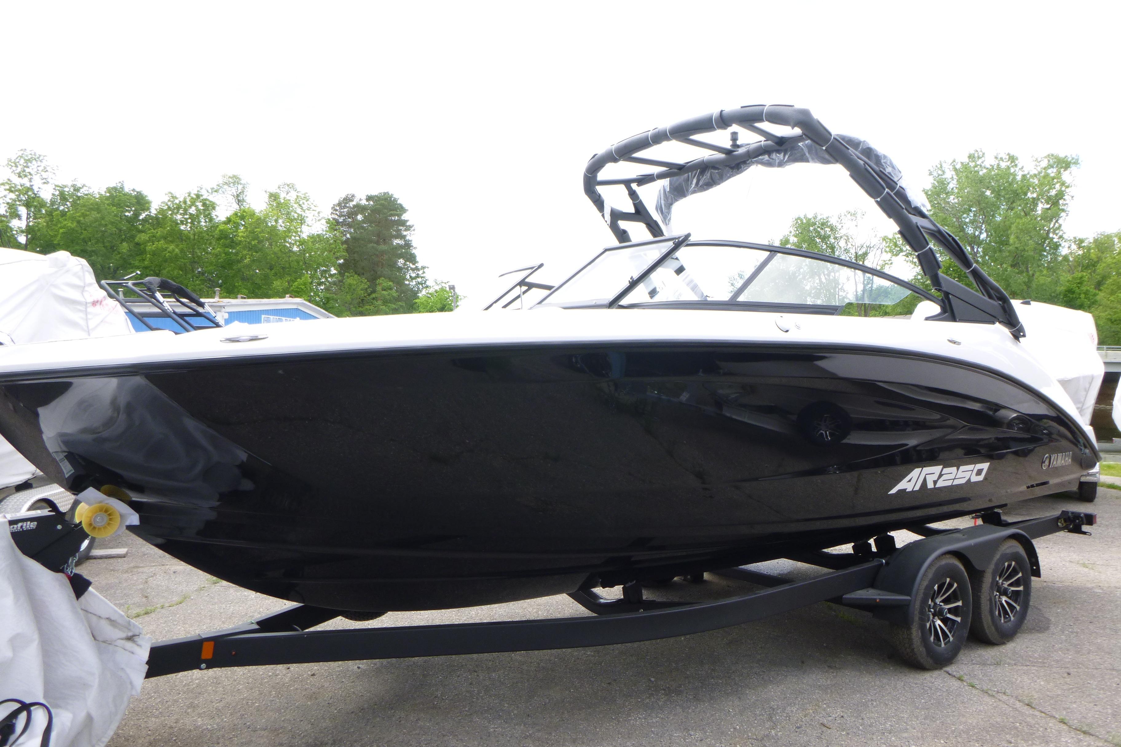 2026 Yamaha Boats AR250 on trailer, sleek black design, parked outdoors.