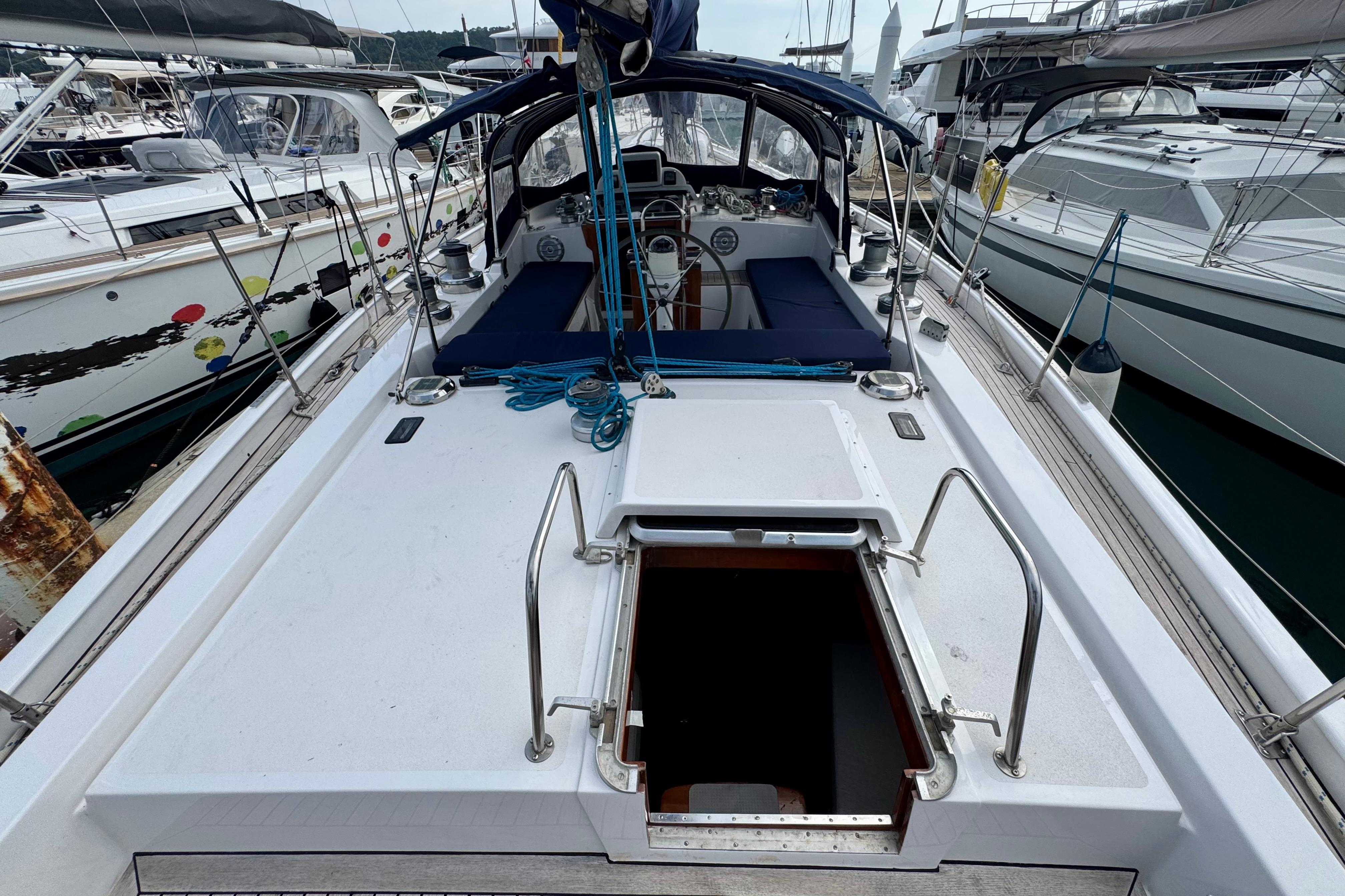 Deck view of a 1981 Ron Holland 52 sailboat docked at a marina.
