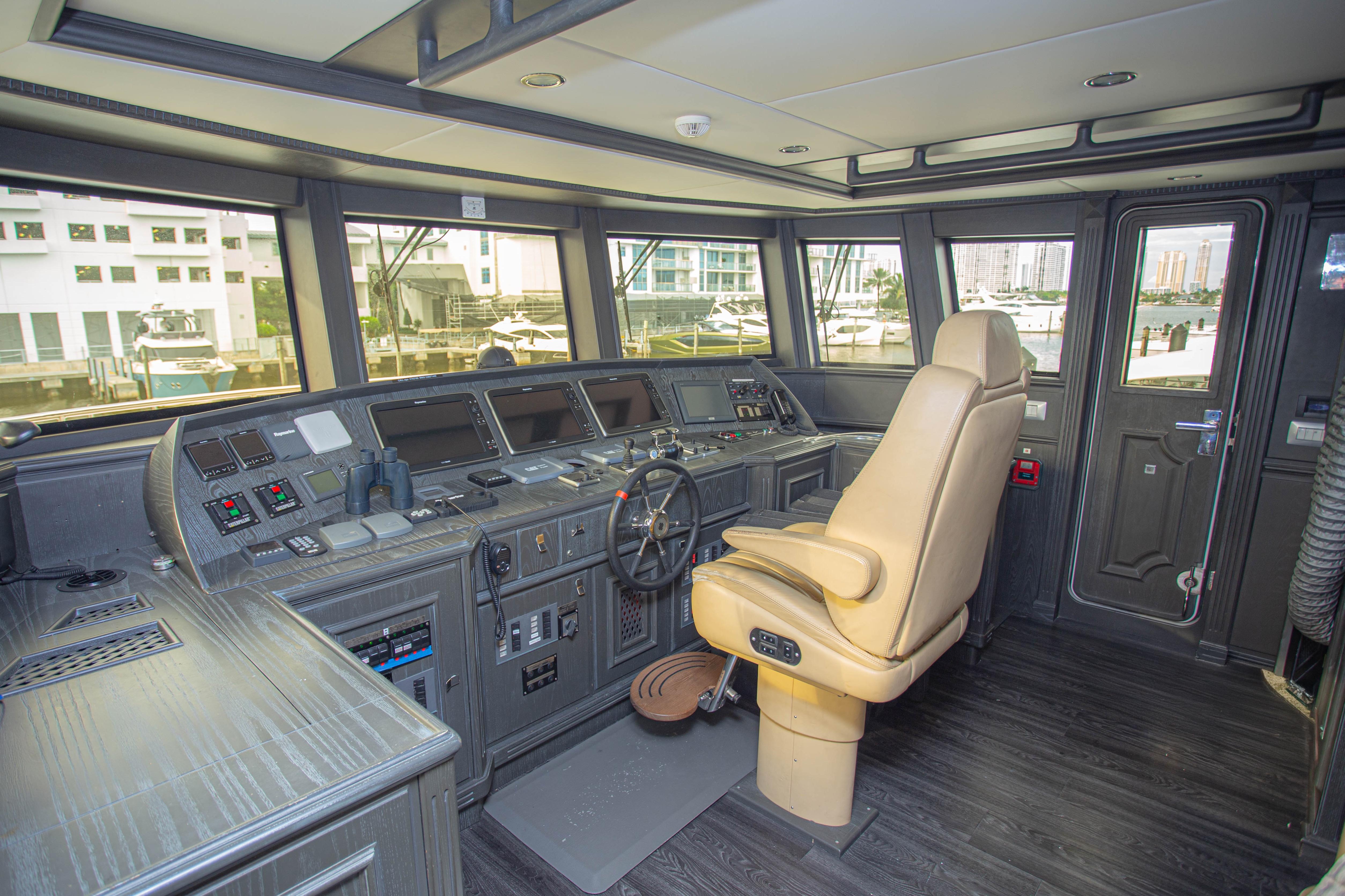 Interior of 2014 Fifth Ocean Yachts 24m Explorer Yacht's helm with advanced navigation controls.