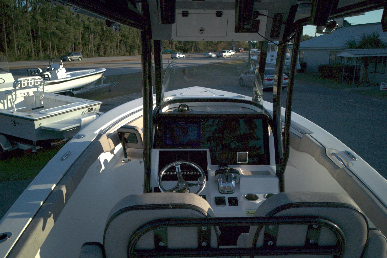 2021 Sea Pro 259 Center Console boat interior with steering wheel and navigation equipment.