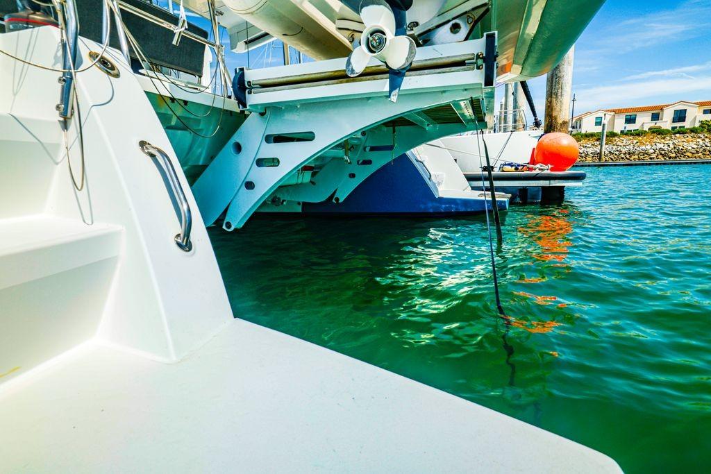 Lagoon 450 F catamaran docked in marina, 2017 model, with clear blue water.