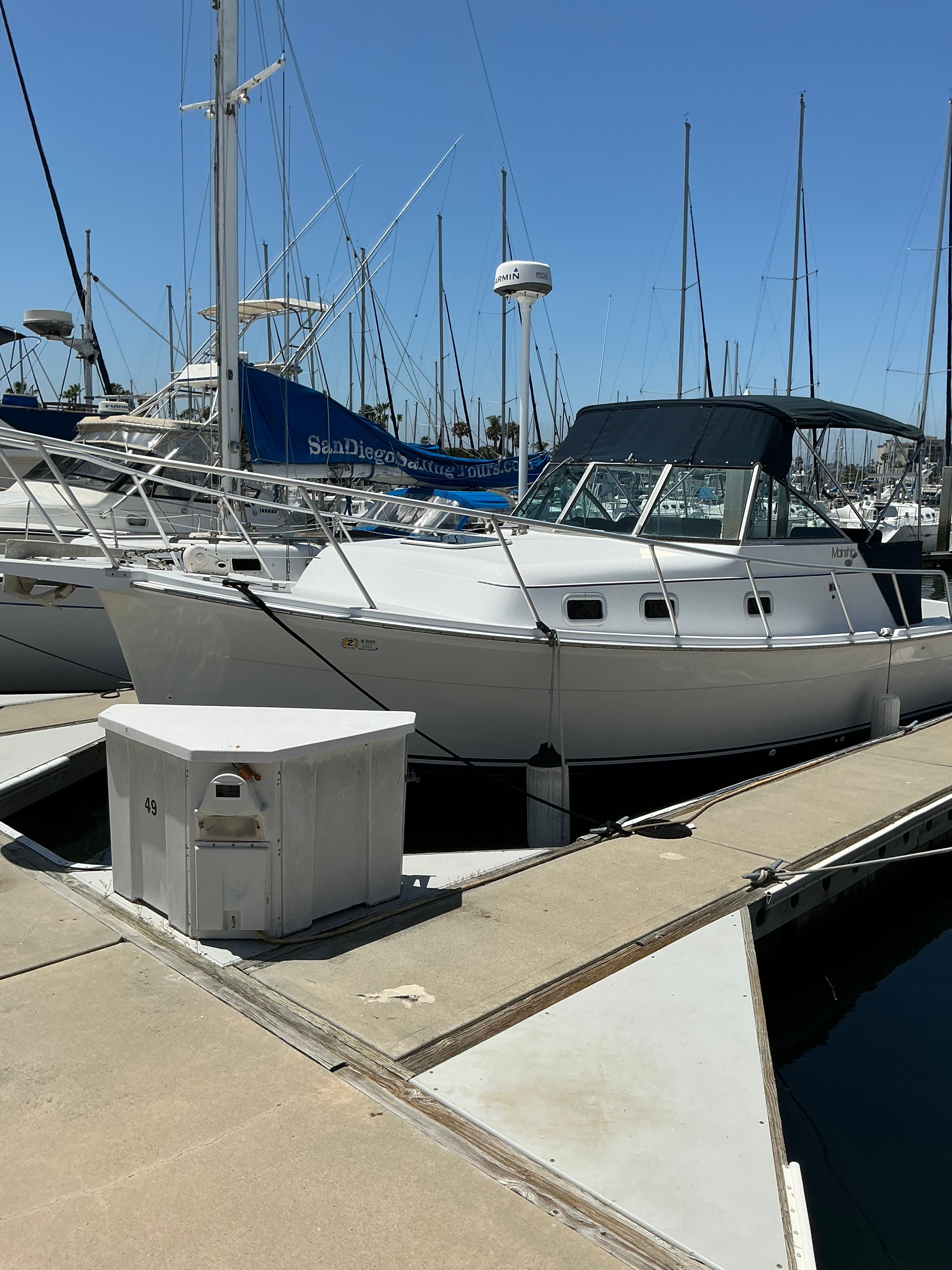 1999 Mainship Pilot 30 boat docked at marina.