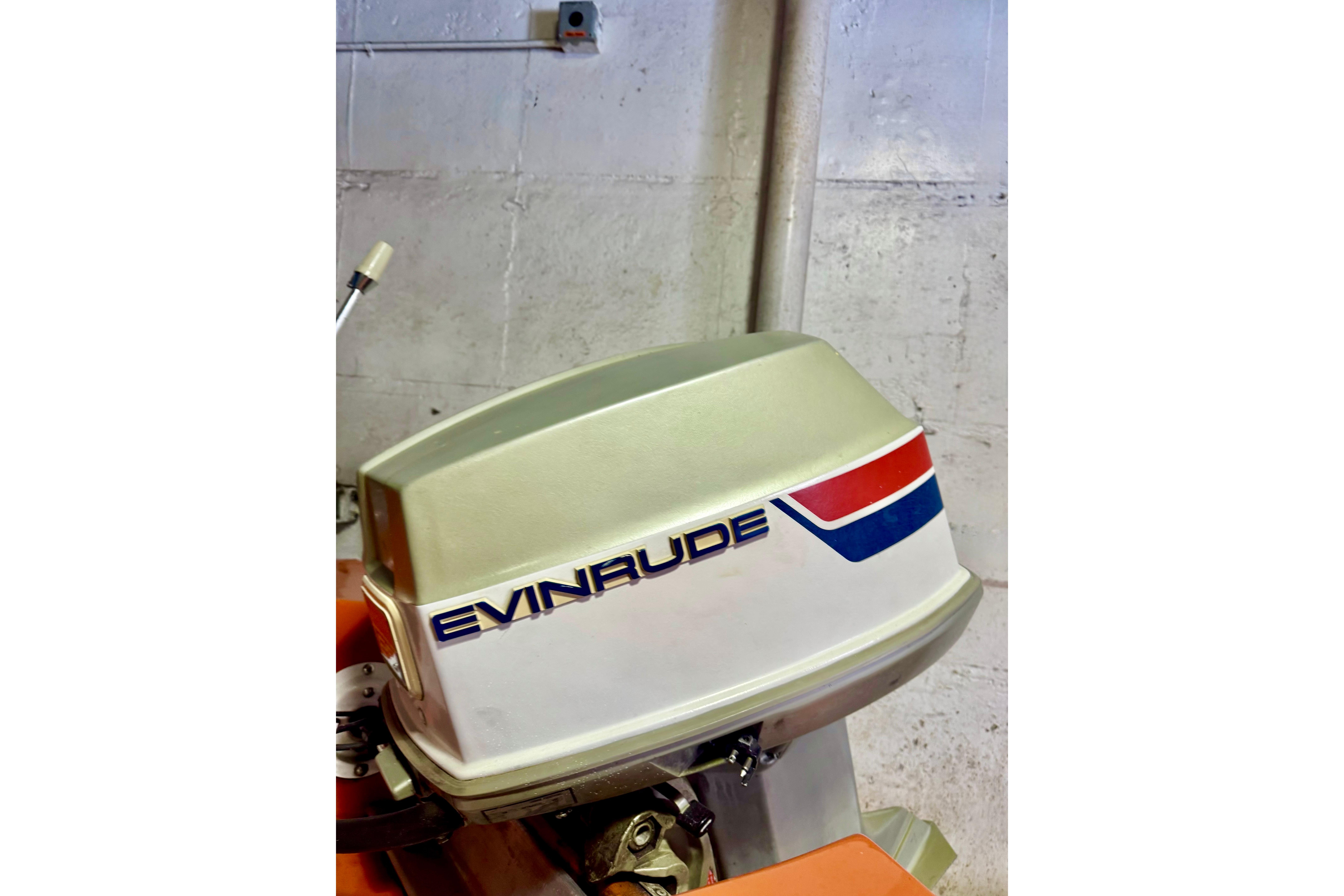 1971 Glastron/Carlson GT 15 with Evinrude outboard motor in a garage setting.
