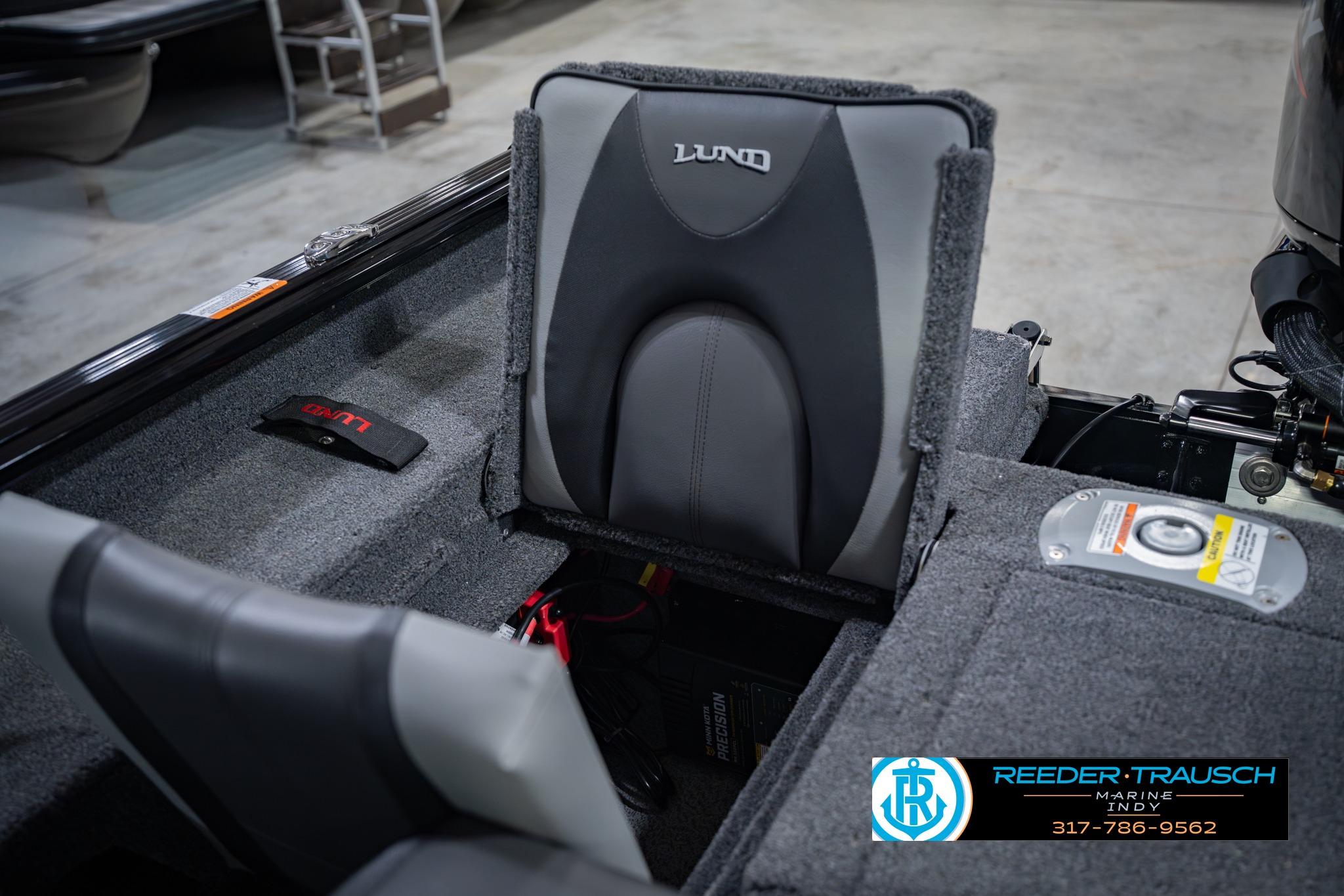 2026 Lund 1775 Impact XS boat interior with gray seating and storage compartments.