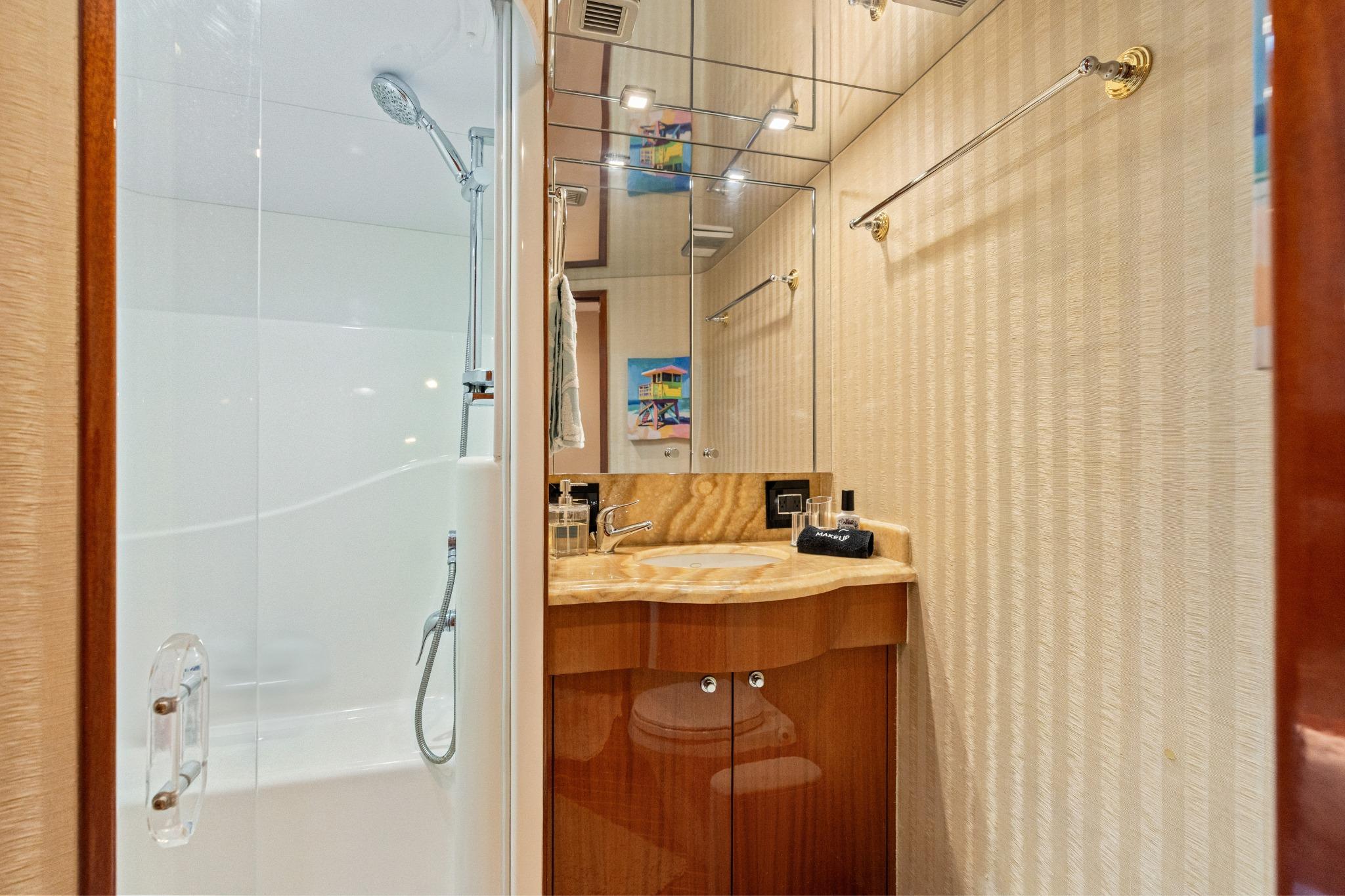 Luxurious bathroom in 2008 Hatteras 64 Motor Yacht with elegant fixtures and modern design.