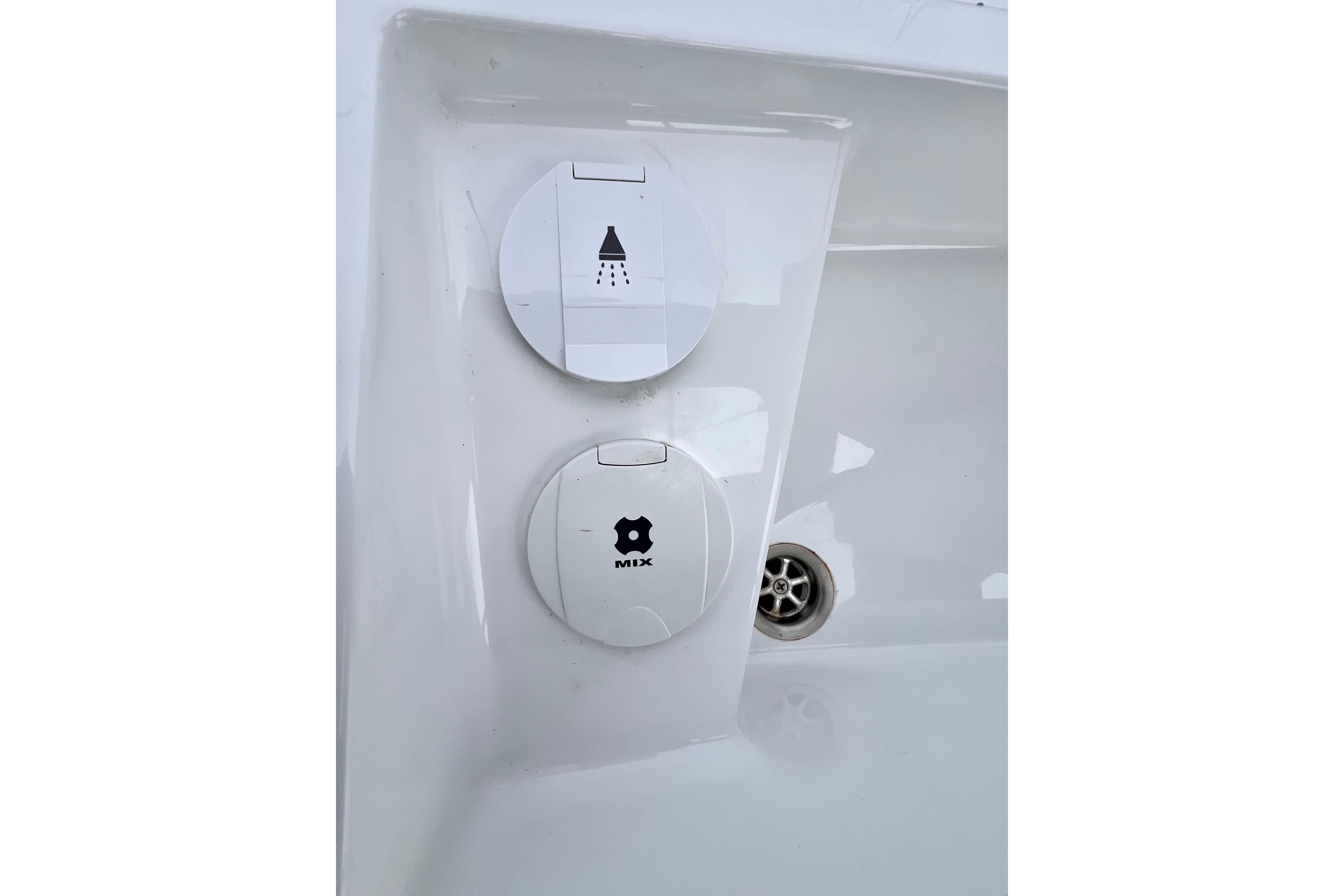 Hanse 455 2016 yacht shower and mixer controls on white panel.