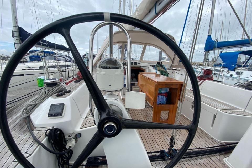 Grand Soleil 50 sailboat cockpit with steering wheel, docked at marina, 2012 model.