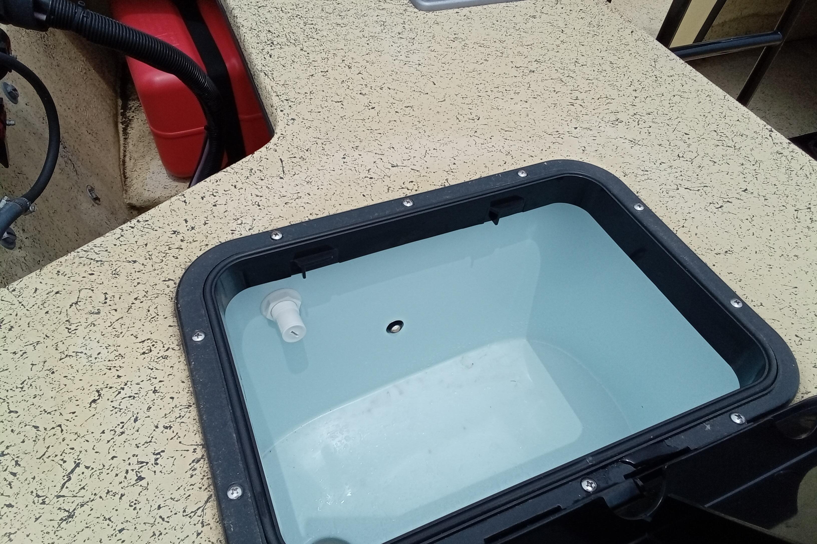 Fibercraft F17 2025 boat interior with open storage compartment and visible wiring.
