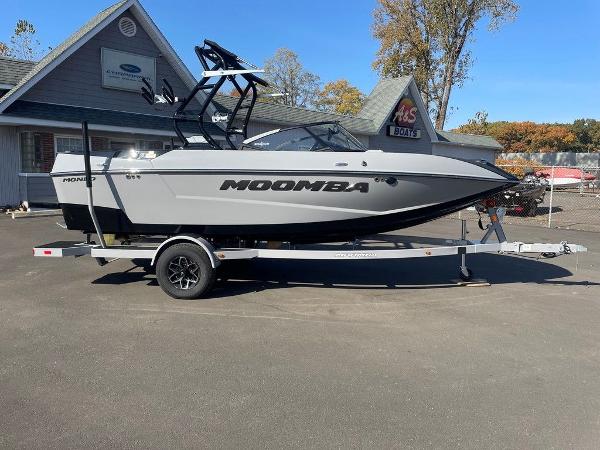 2025 Moomba Mondo boat on trailer, parked outside dealership, clear sky.