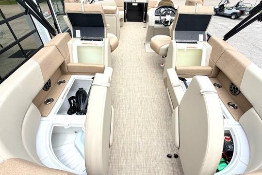 2026 Manitou Aurora RF 23 boat interior with beige seating and storage compartments.