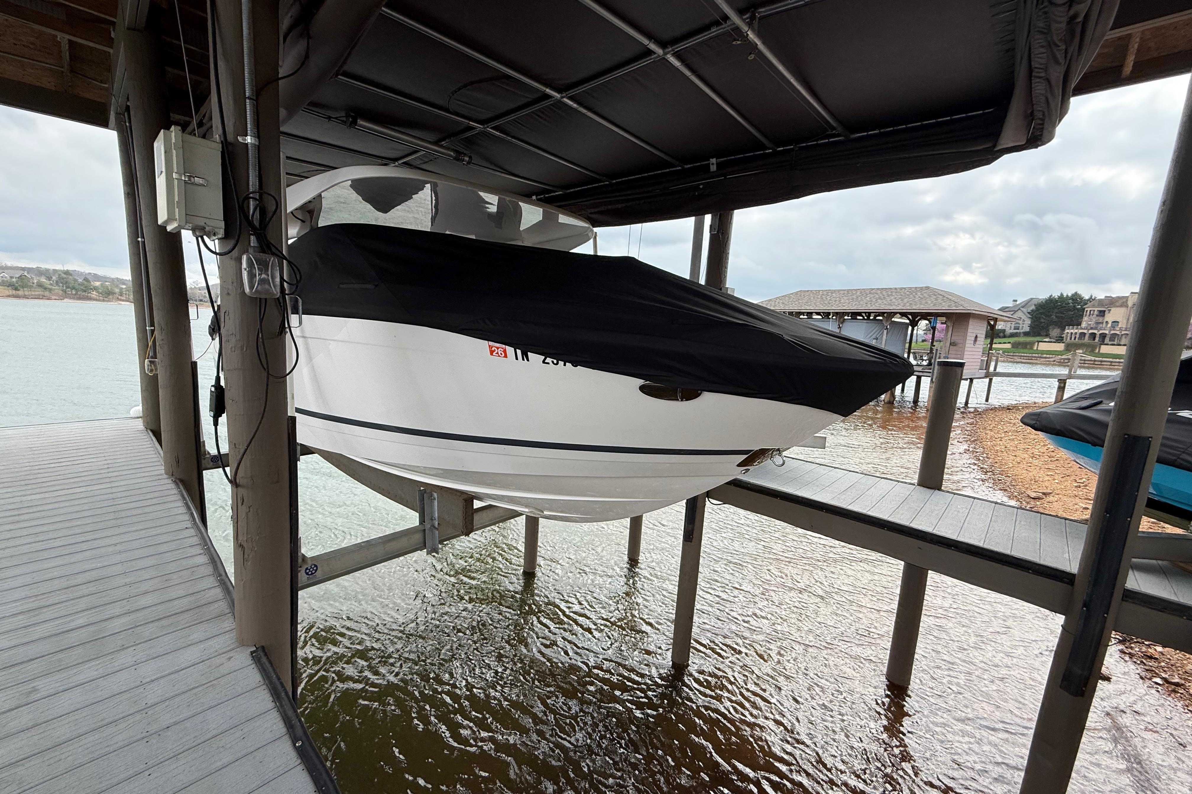 2024 Regal LS4 boat covered and docked by a lakeside pier.
